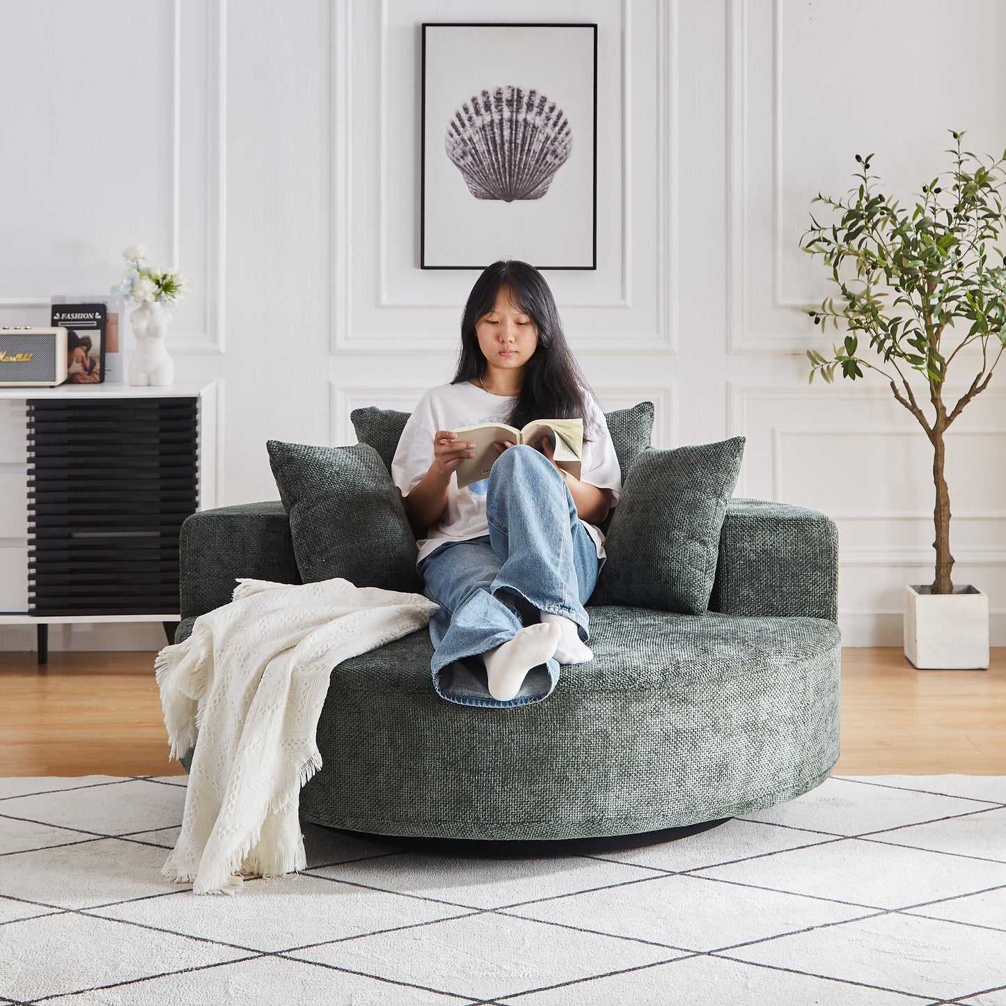 A plush circular emerald green boucle sofa provides a cozy seating option