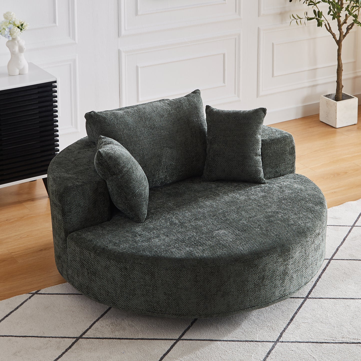 Plush round accent chair in dark teal textured fabric with matching throw pillows for cozy seating