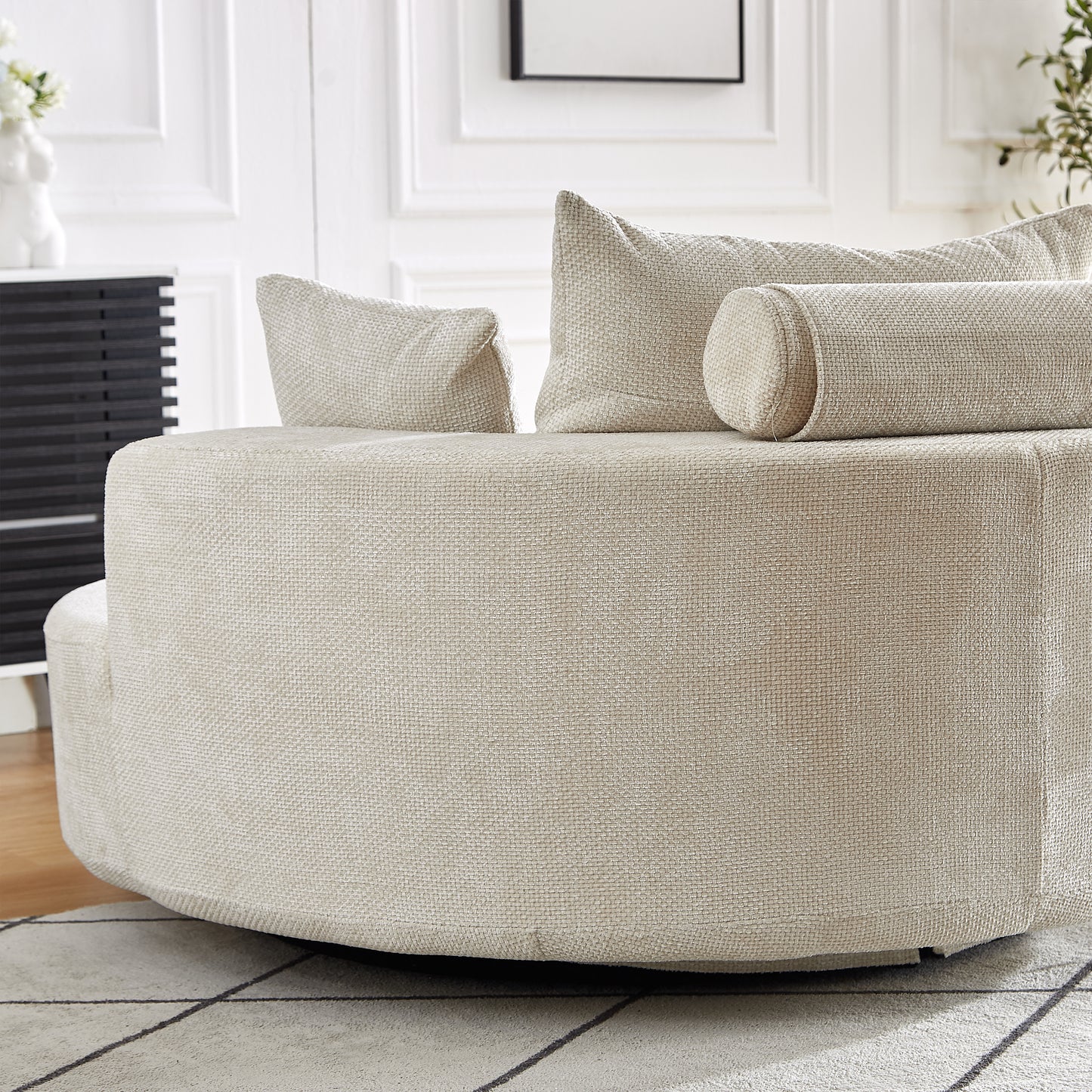 Textured beige fabric swivel armchair with plush back cushions and a bolster pillow