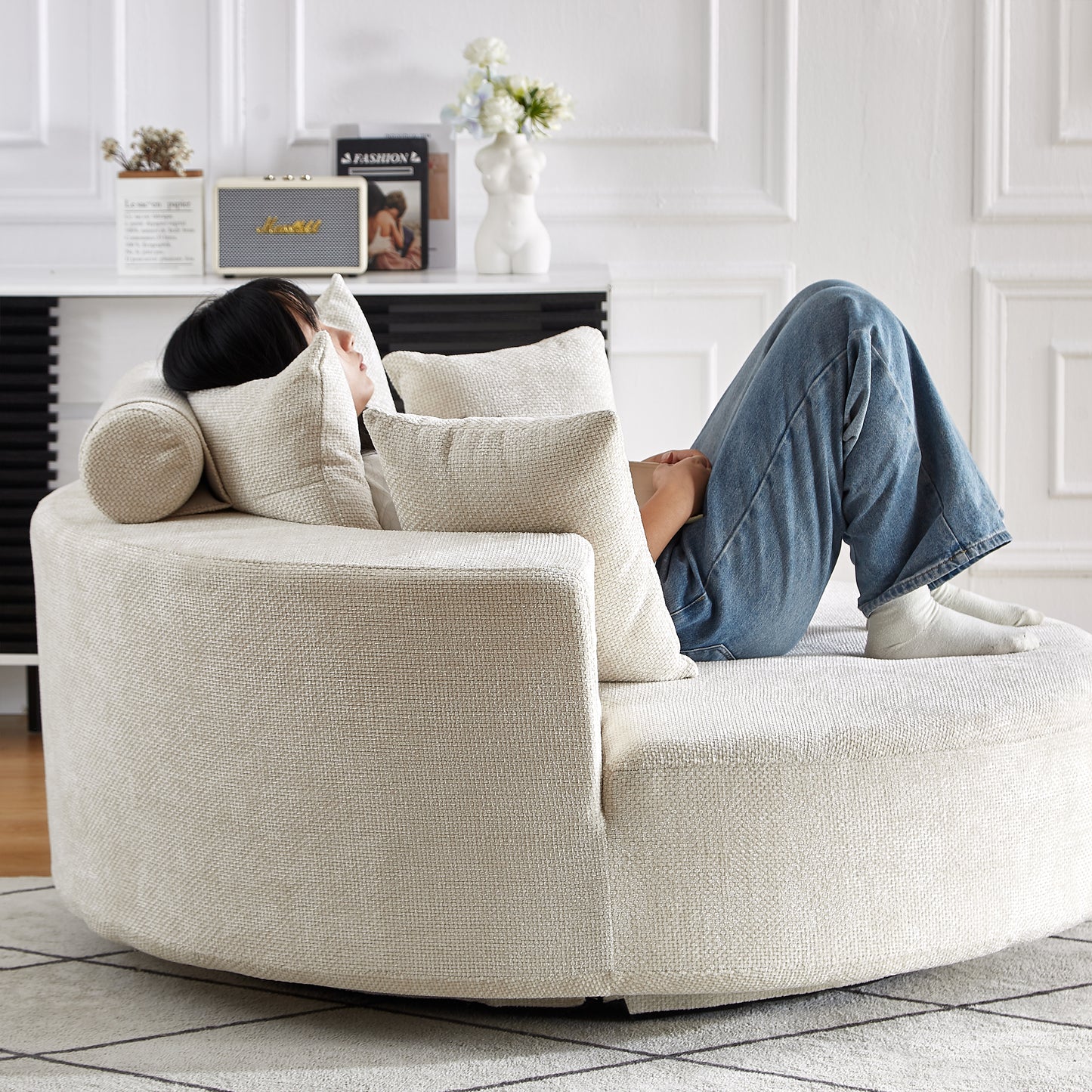Creamcolored round sectional sofa with textured fabric upholstery featuring plush cushions for ultimate relaxation