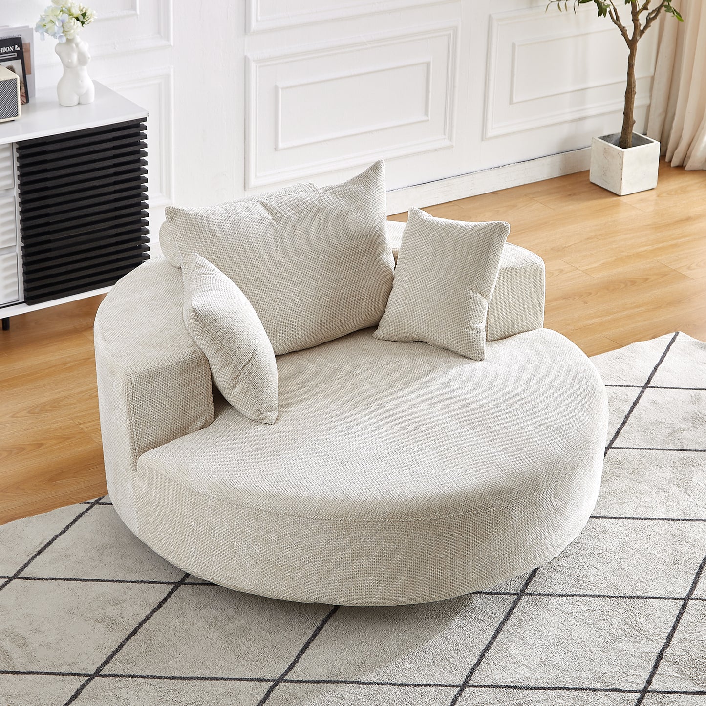 Plush circular accent chair in cream fabric with textured weave offering cozy seating