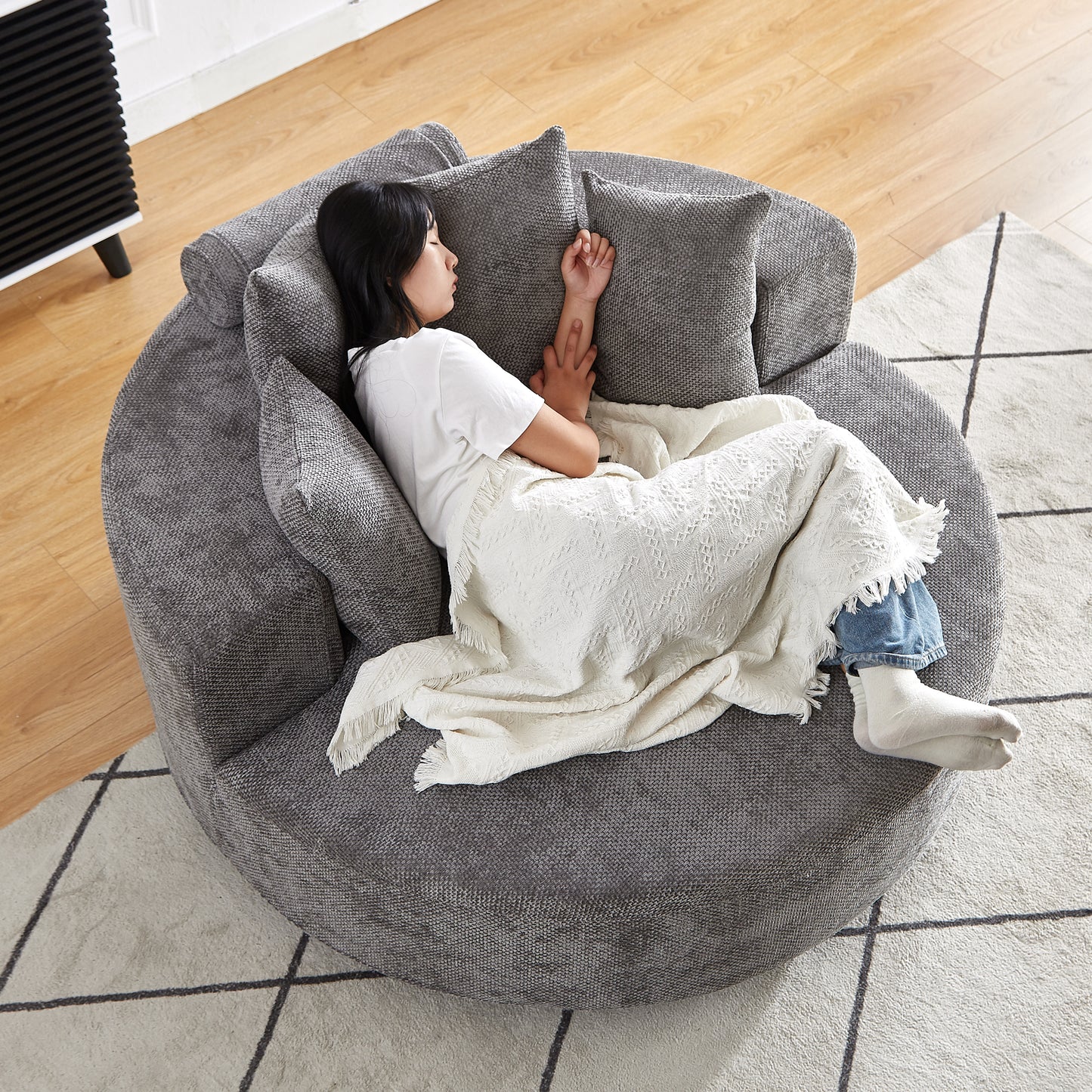 Plush grey swivel chair with textured fabric perfect for cozy living rooms