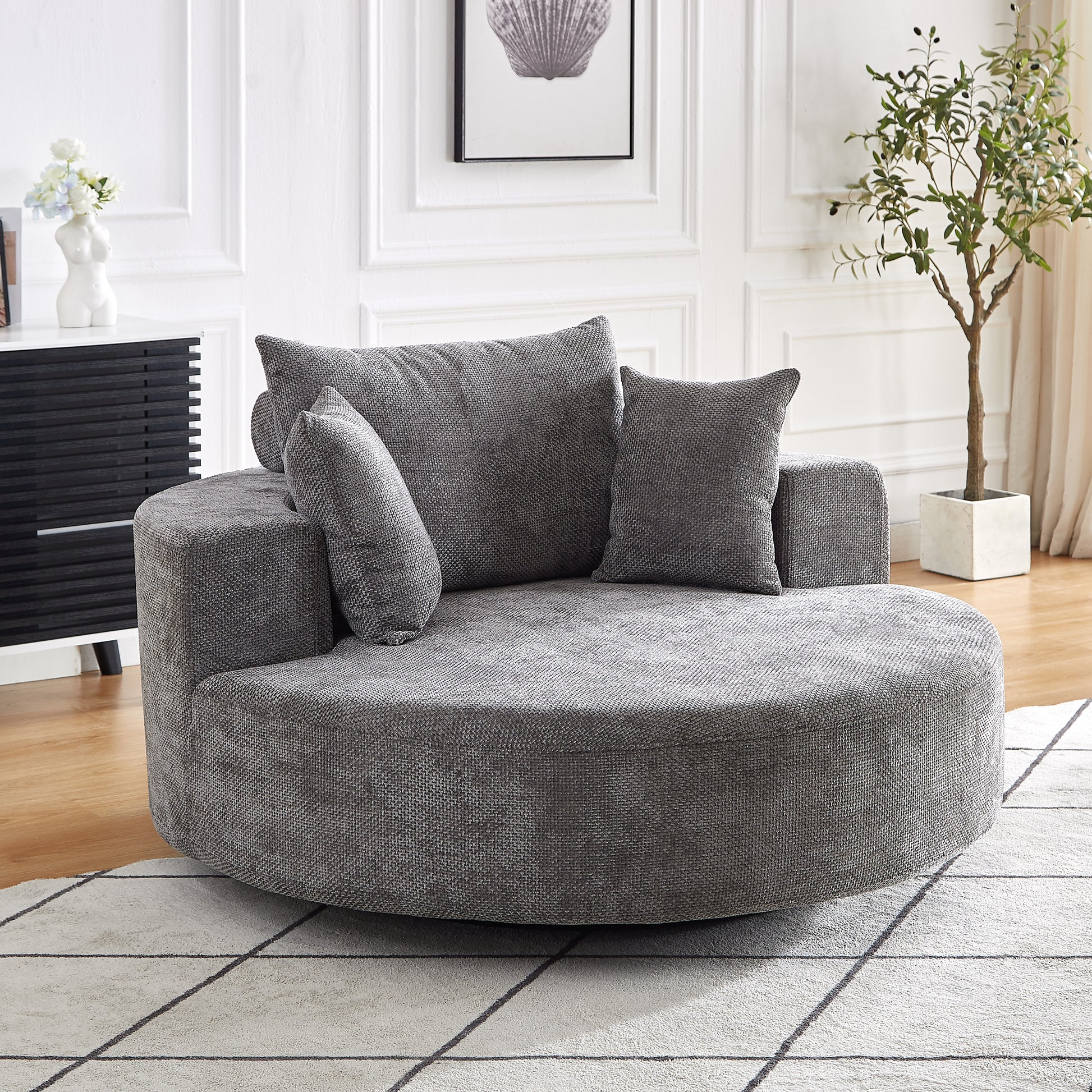 Plush grey fabric swivel barrel chair with deep seating perfect for a cozy living room