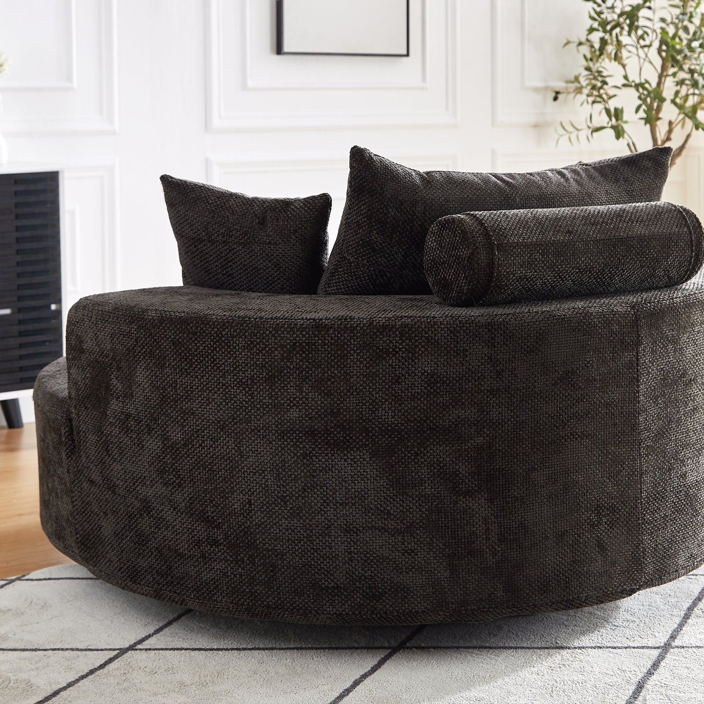 Dark charcoal grey swivel sofa with textured fabric and accent pillows