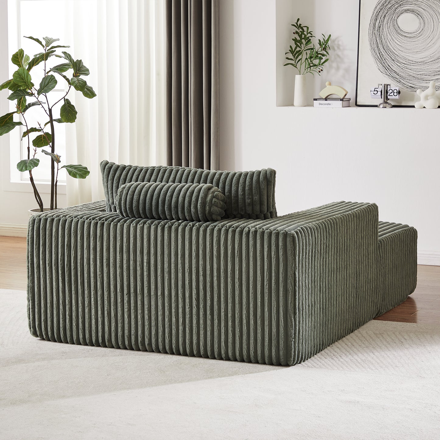 Sage green corduroy modular sofa with plush throw pillows