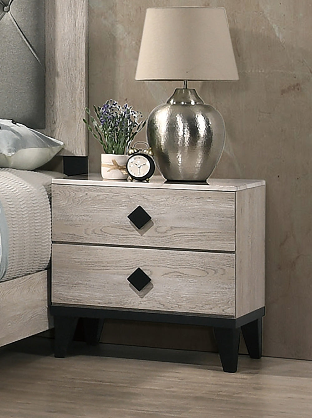Distressed wood bedside table with two drawers featuring black diamond pulls part of a modern bedroom set