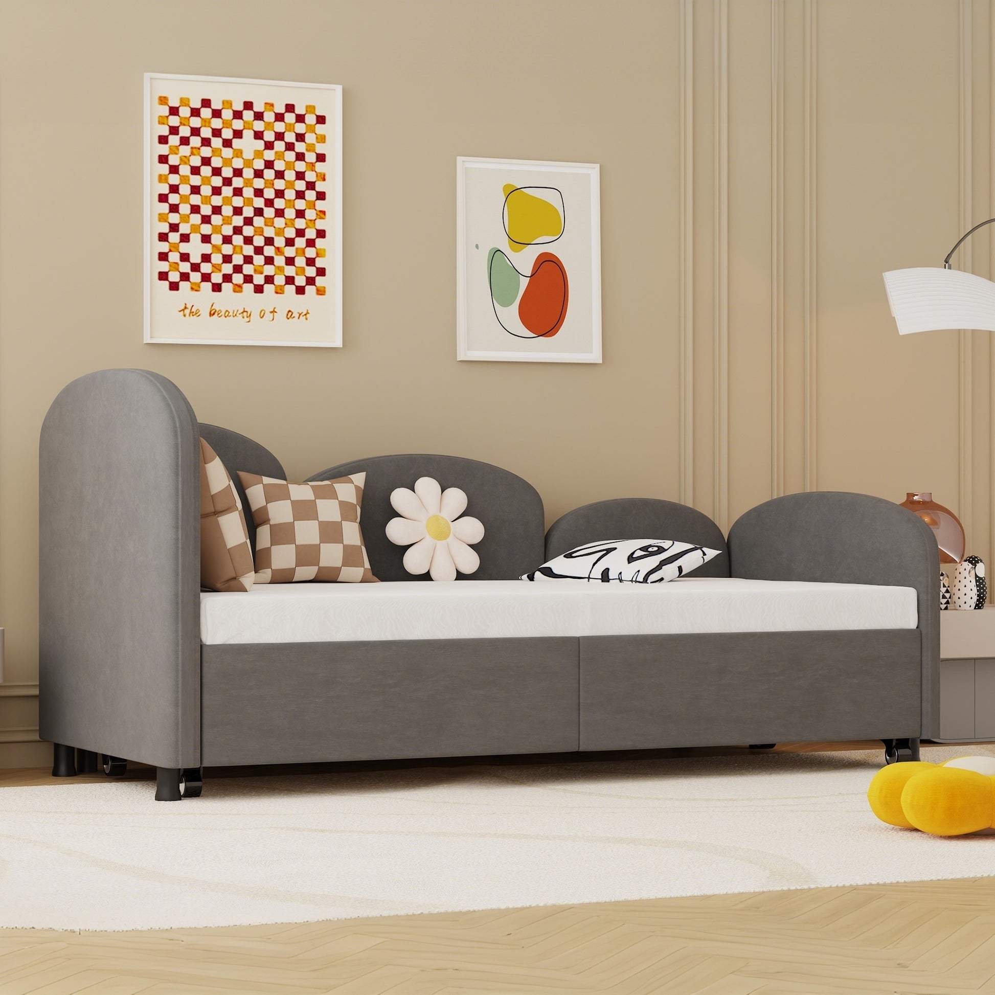 Grey upholstered daybed with rounded arms perfect for a childs bedroom
