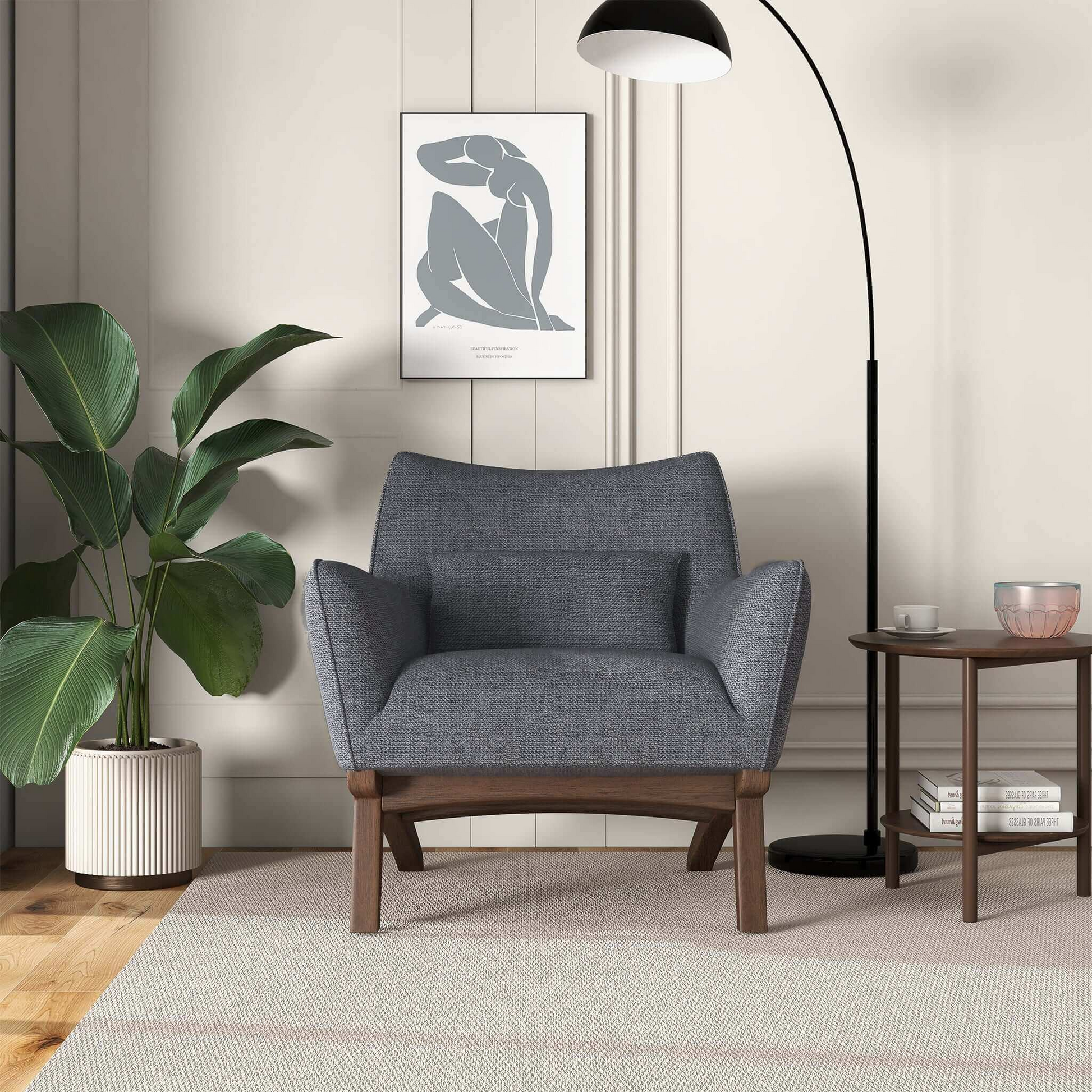 Modern armchair in textured blue fabric with dark wood legs and matching lumbar pillow