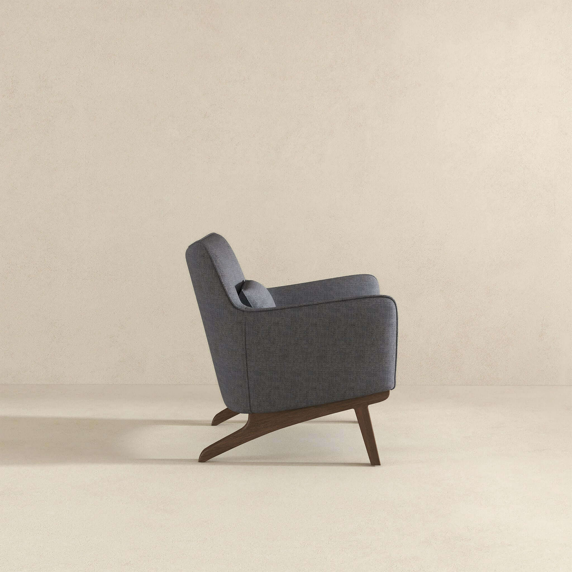 Midcentury modern accent chair in dark gray fabric with angled wooden legs