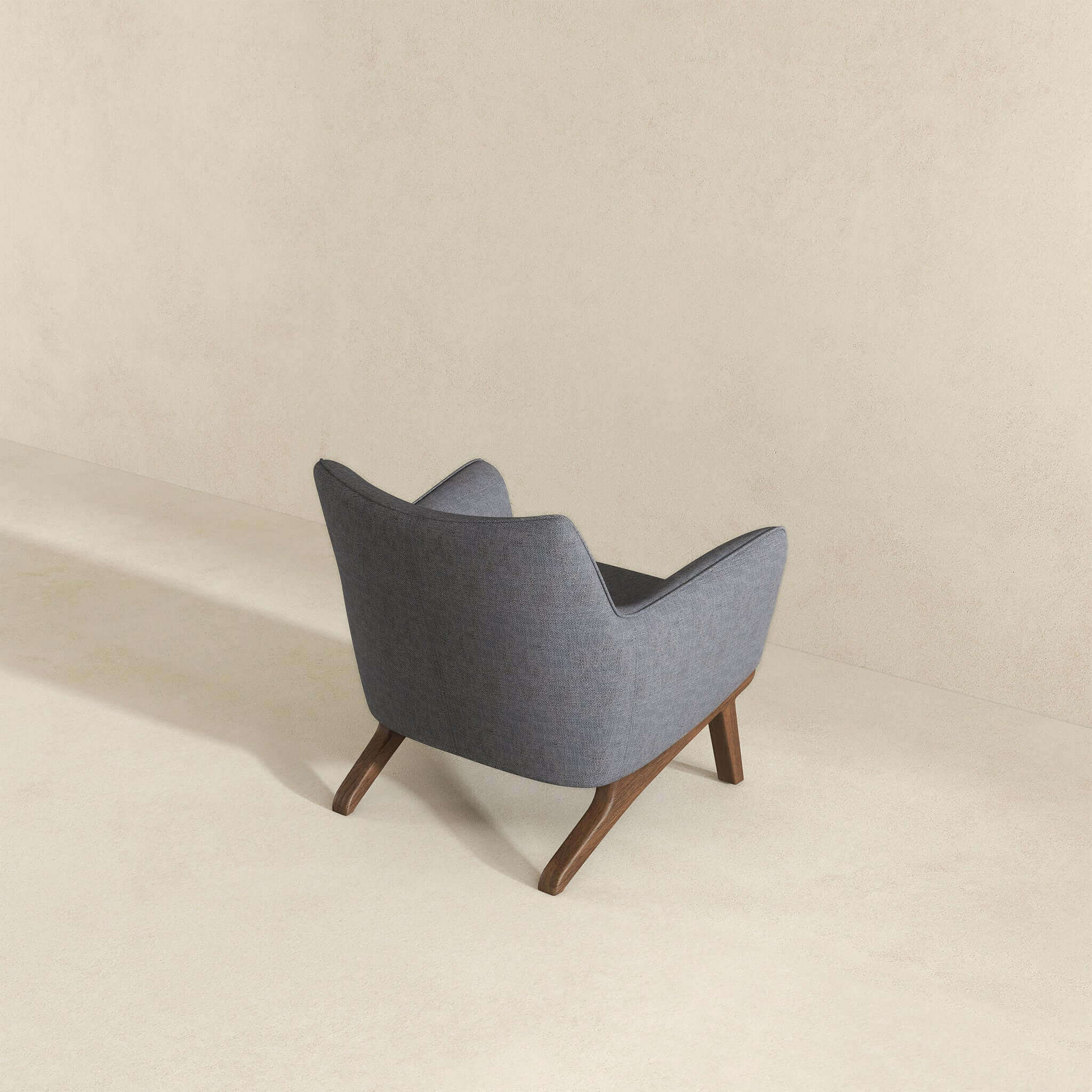 Midcentury modern accent chair in textured grey fabric with angled wooden legs