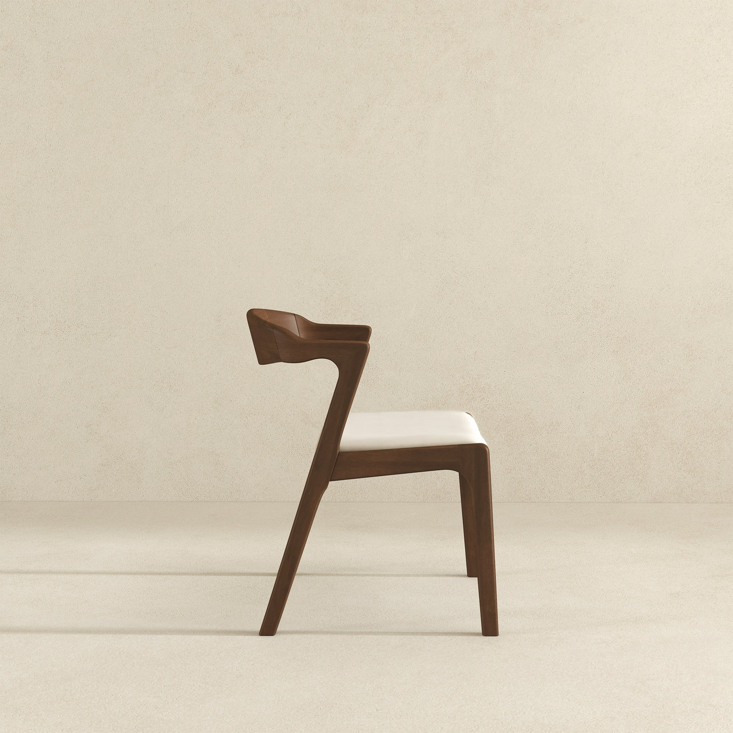 Modern walnut dining chair with a cream upholstered seat and curved armrests