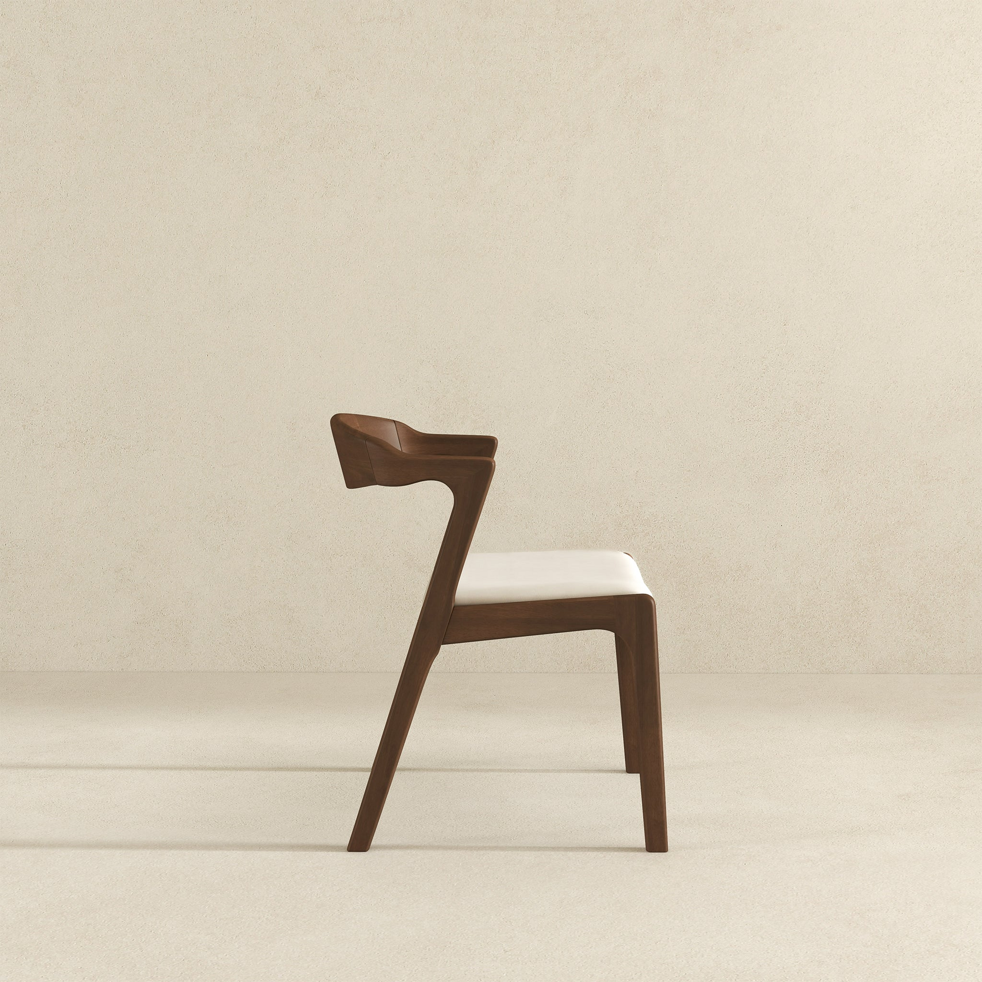 Modern walnut dining chair with a cream upholstered seat and curved armrests