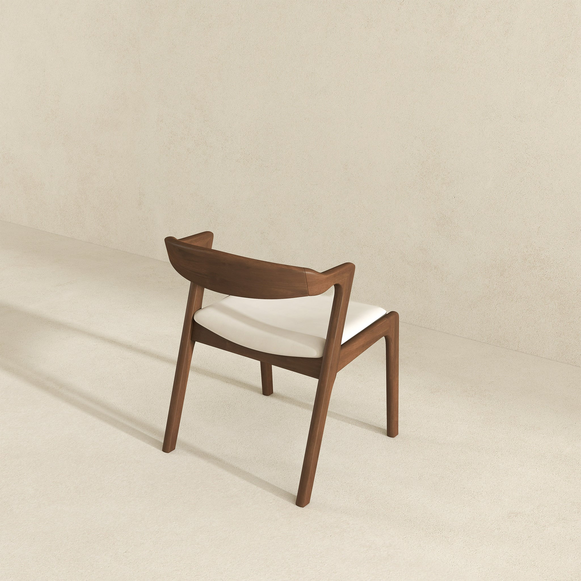 Modern walnut dining chair with a curved wooden backrest and white upholstered seat