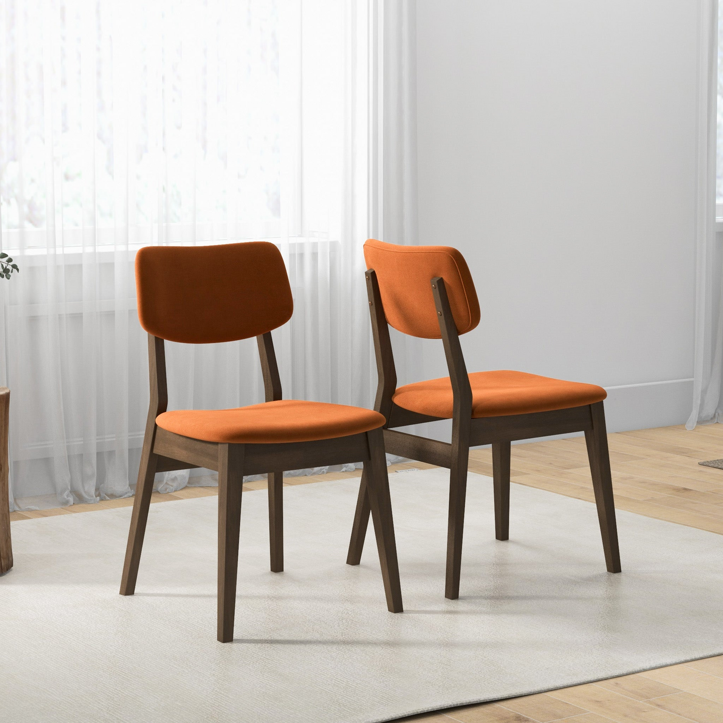 Two modern dining chairs with burnt orange upholstered seats and dark wood frames