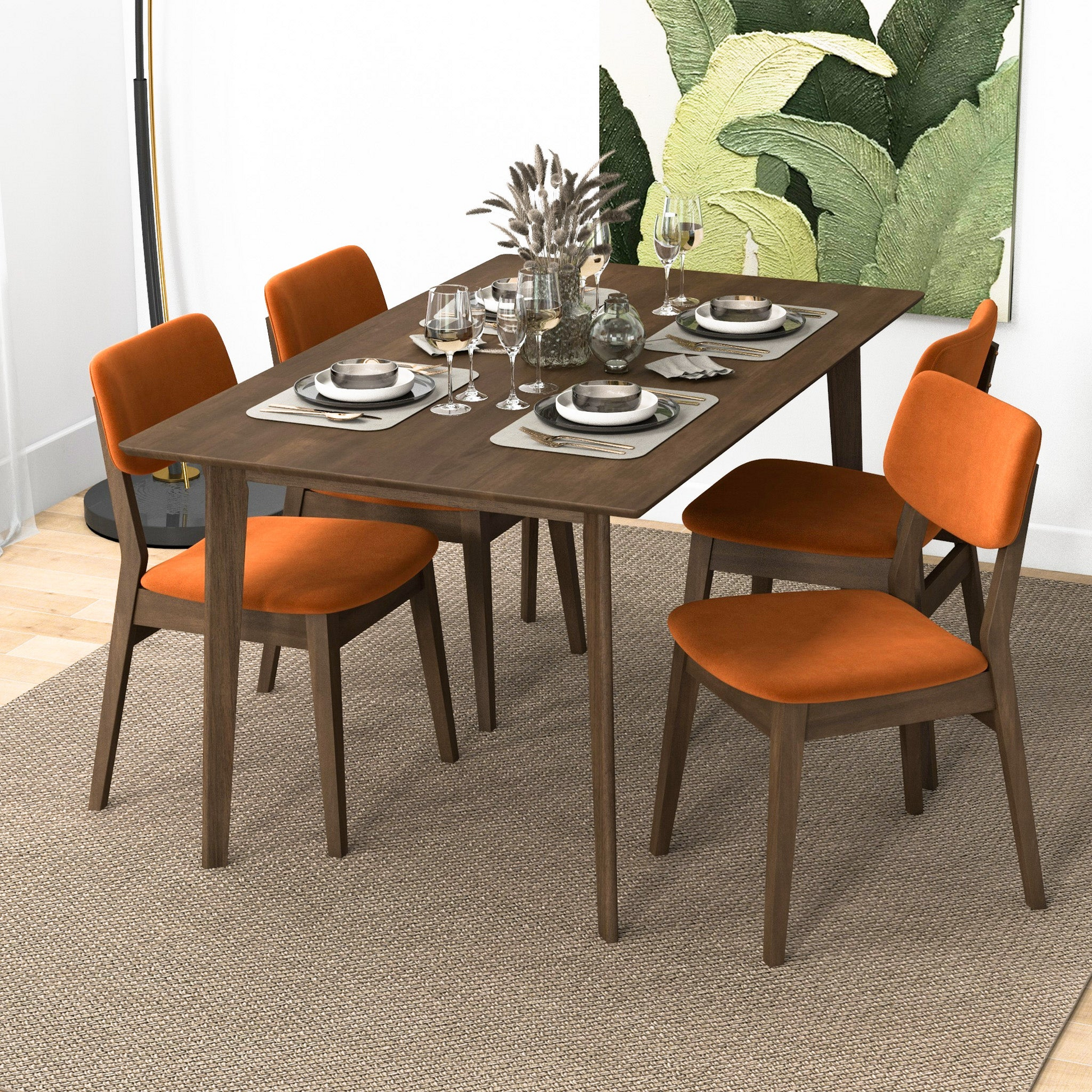 Modern dining set featuring a dark wood table with four orange velvet chairs on a textured rug