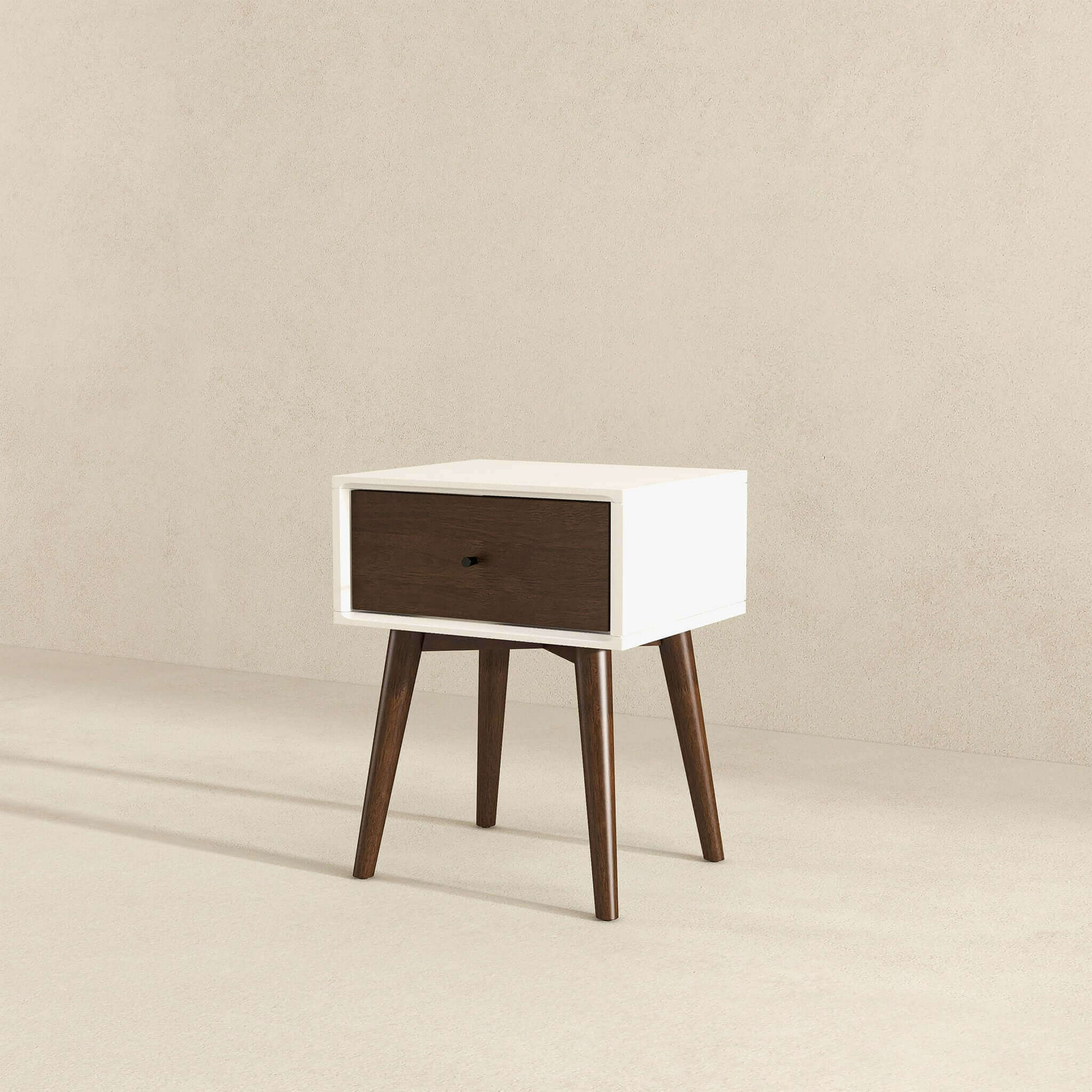 White midcentury modern nightstand with walnut drawer and tapered legs