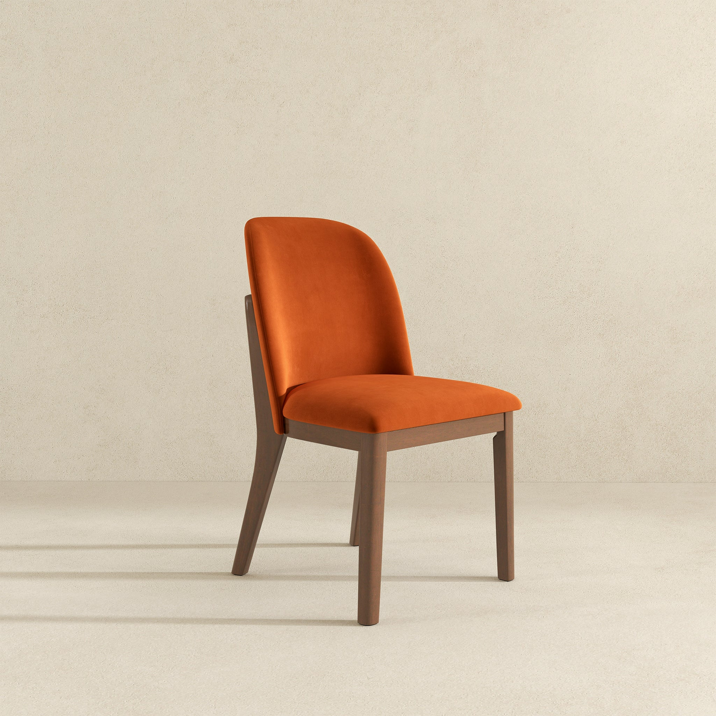 Orange velvet dining chair with a wooden frame modern design