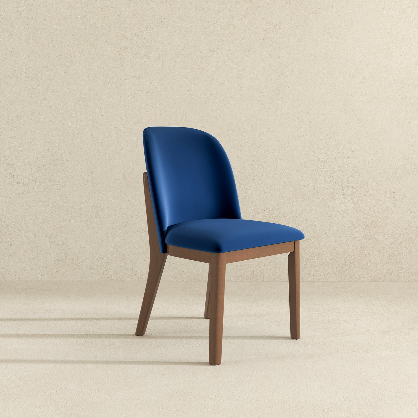 Blue velvet dining chair with natural wood frame and curved backrest