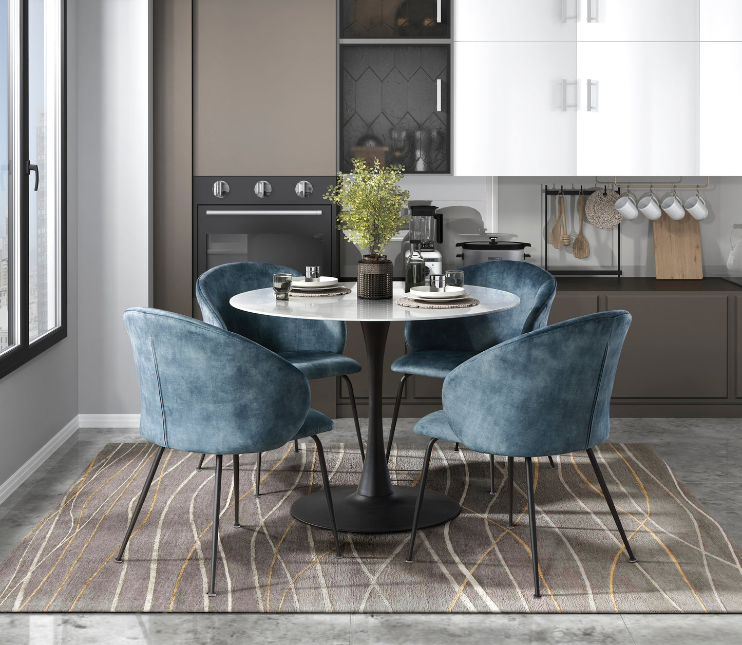 Four blue velvet dining chairs surround a white marbletop tulip table