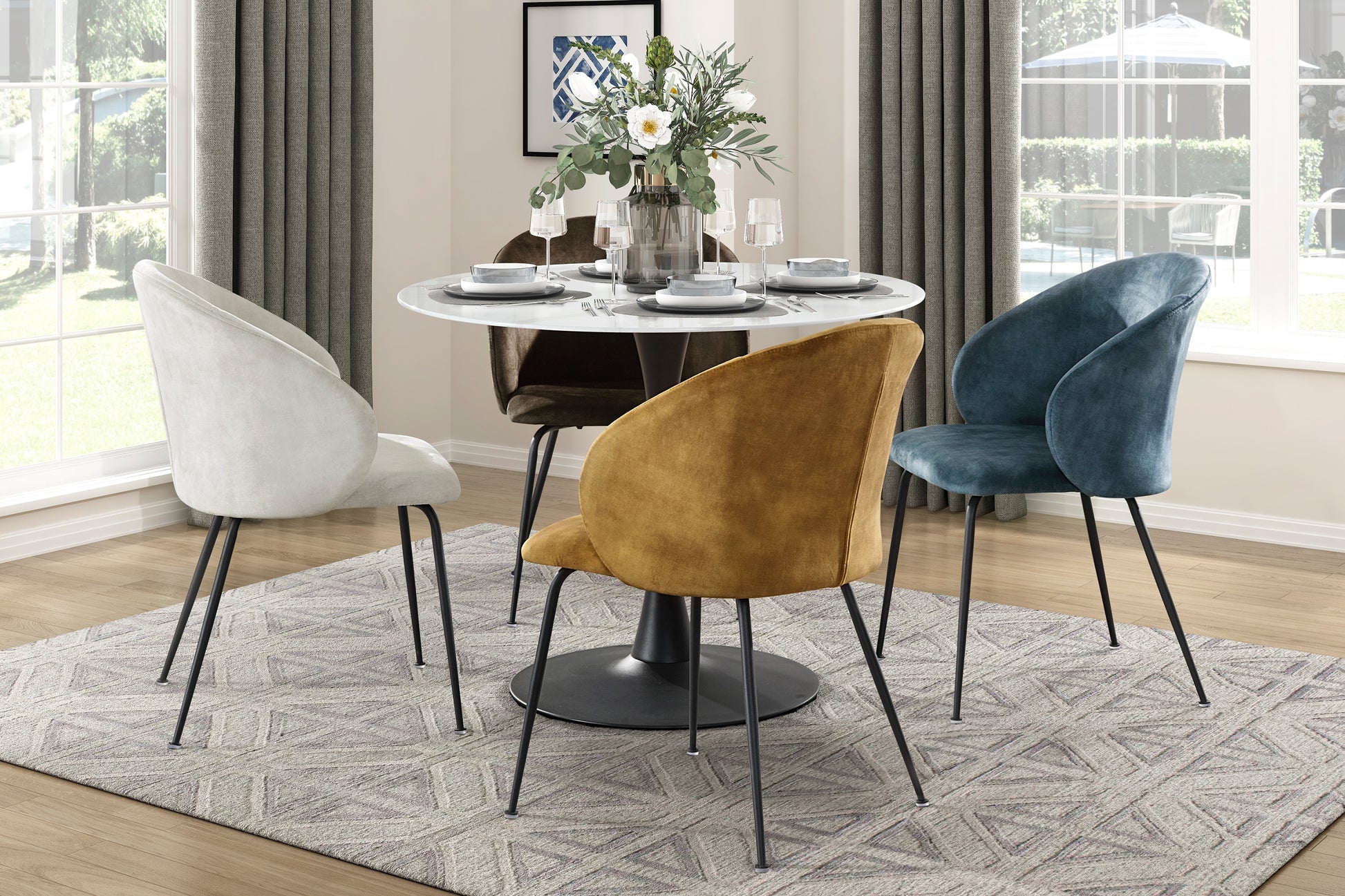 Plush velvet dining chair in deep teal featuring a sleek silhouette and black metal legs