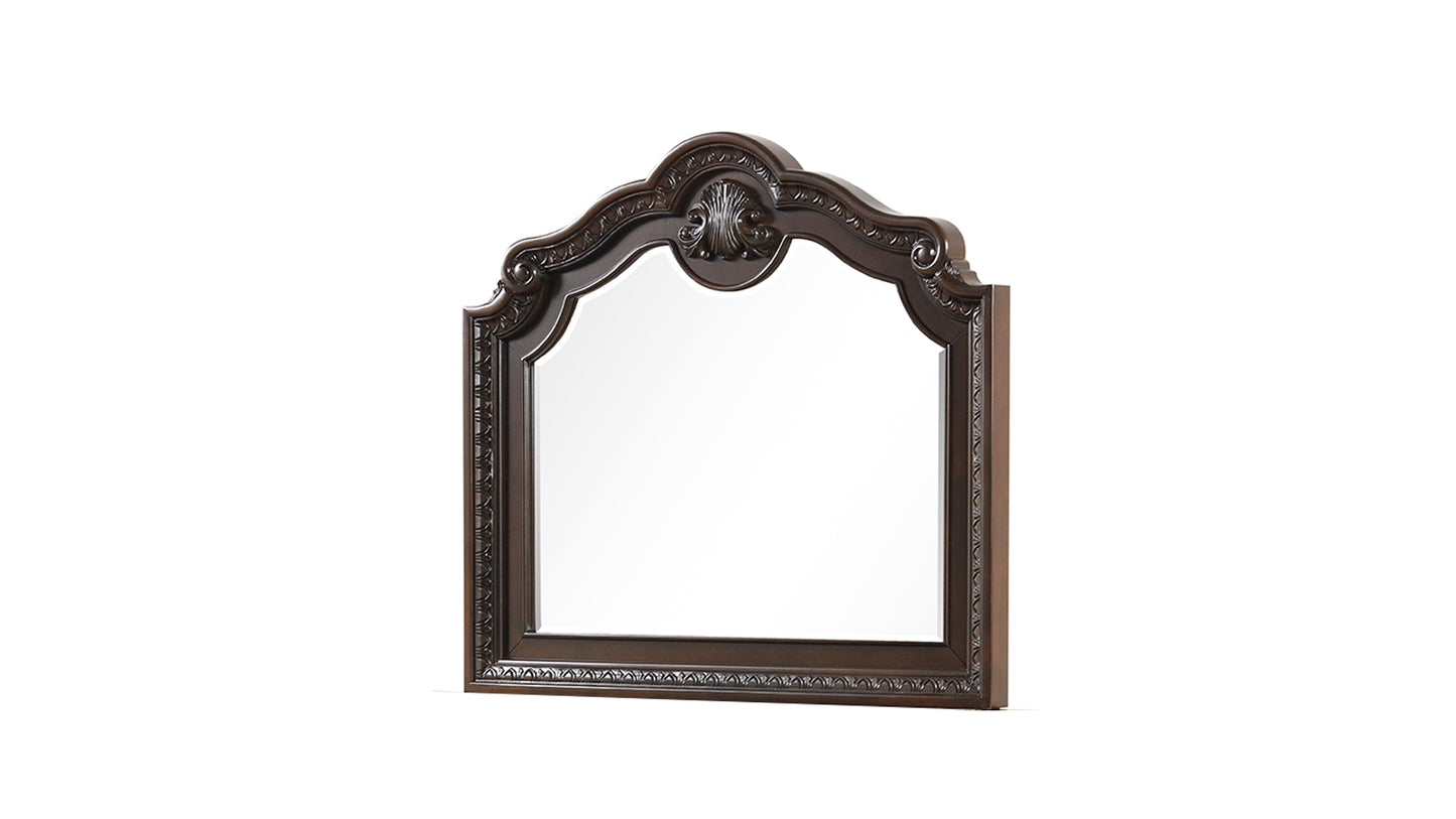 Ornate dark wood dresser mirror with carved details and a scrolled top