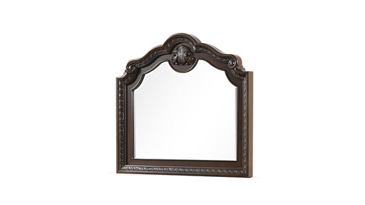 Ornate dark wood dresser mirror with carved details and a scrolled top