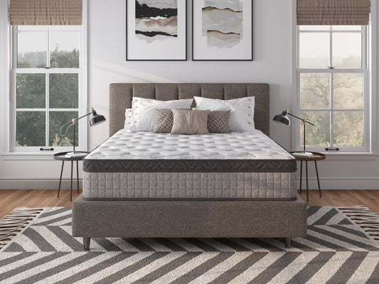 Plush hybrid mattress with white damask pattern gray border on a modern bed frame