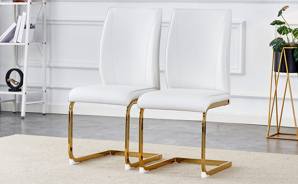 Modern white faux leather dining chairs with sleek gold sled legs sold as a set