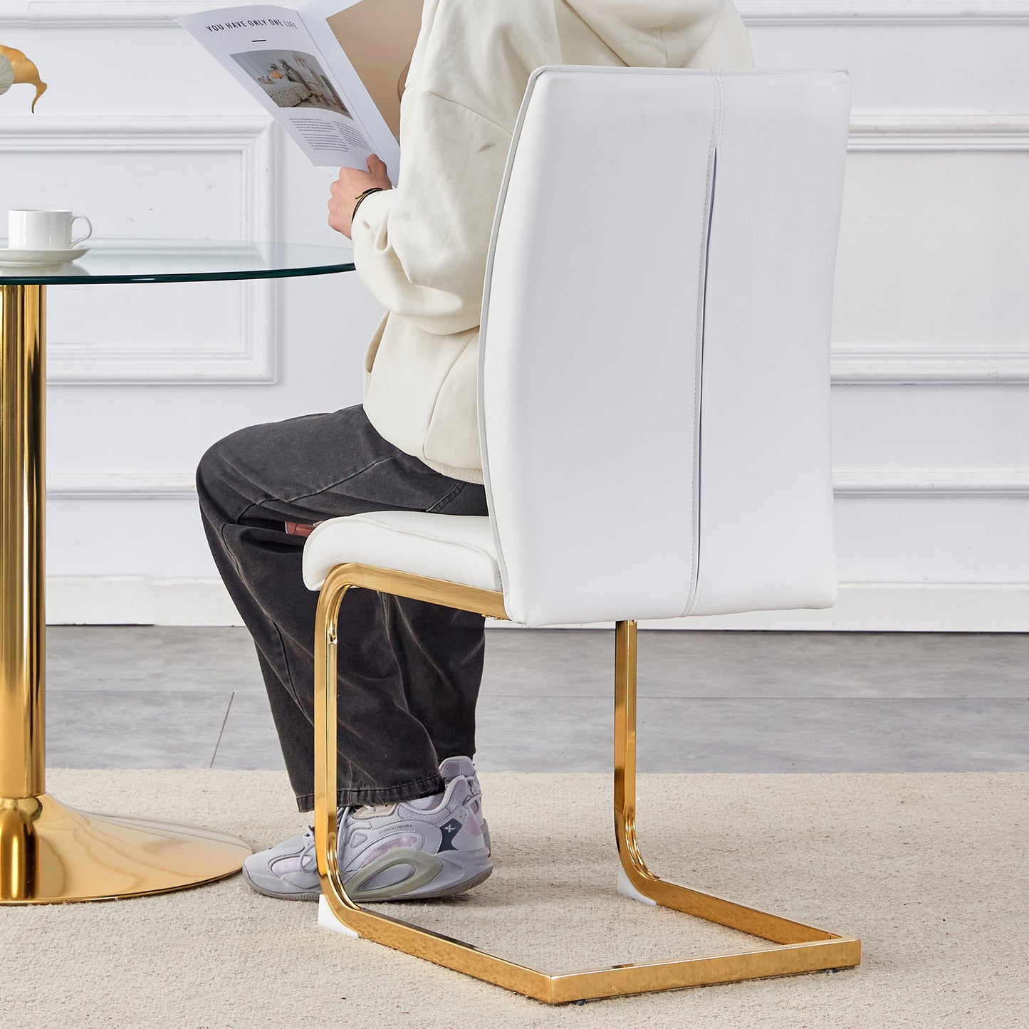 Modern white faux leather dining chair with gold chrome base