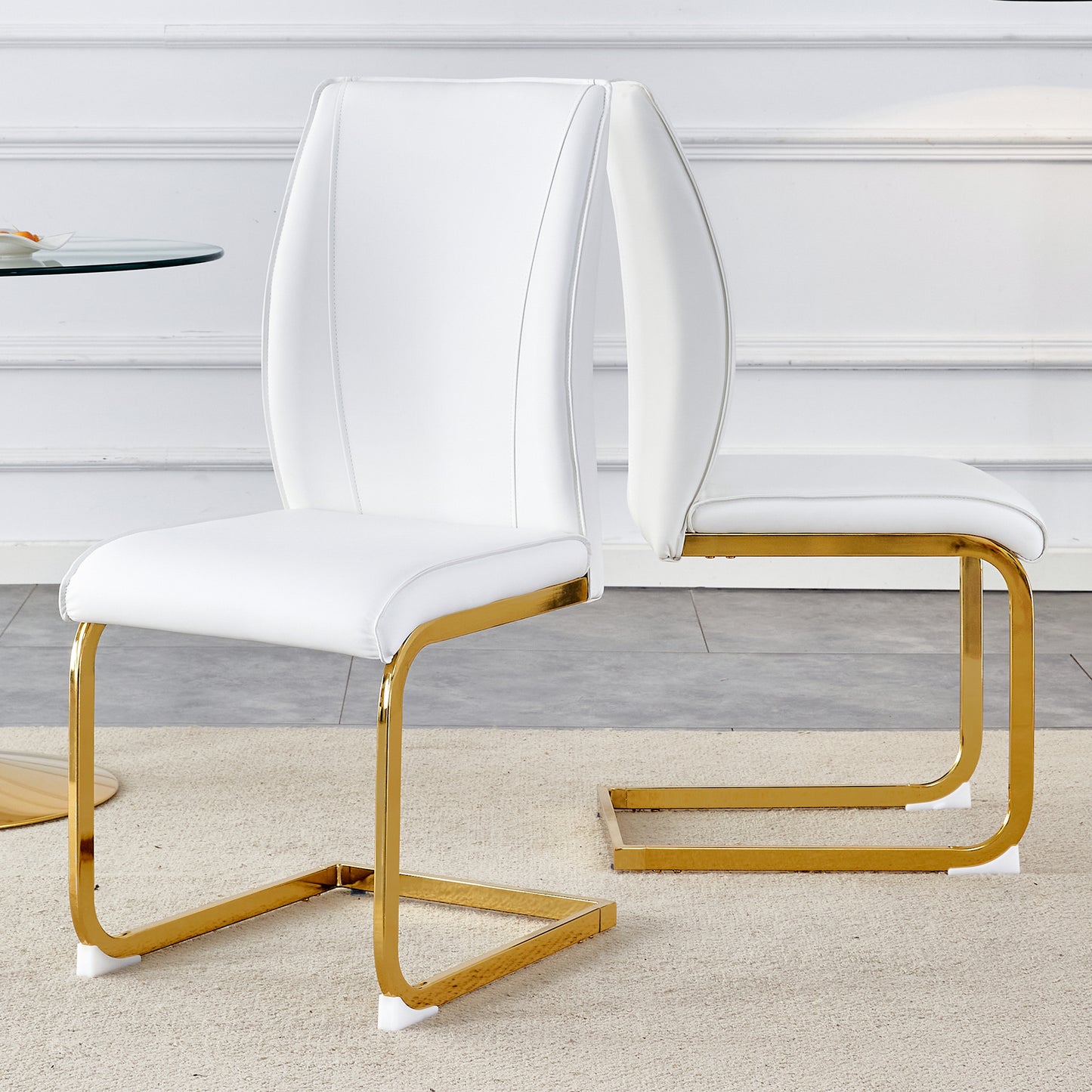 White leather dining chair with polished gold cantilever base and elegant stitching detail