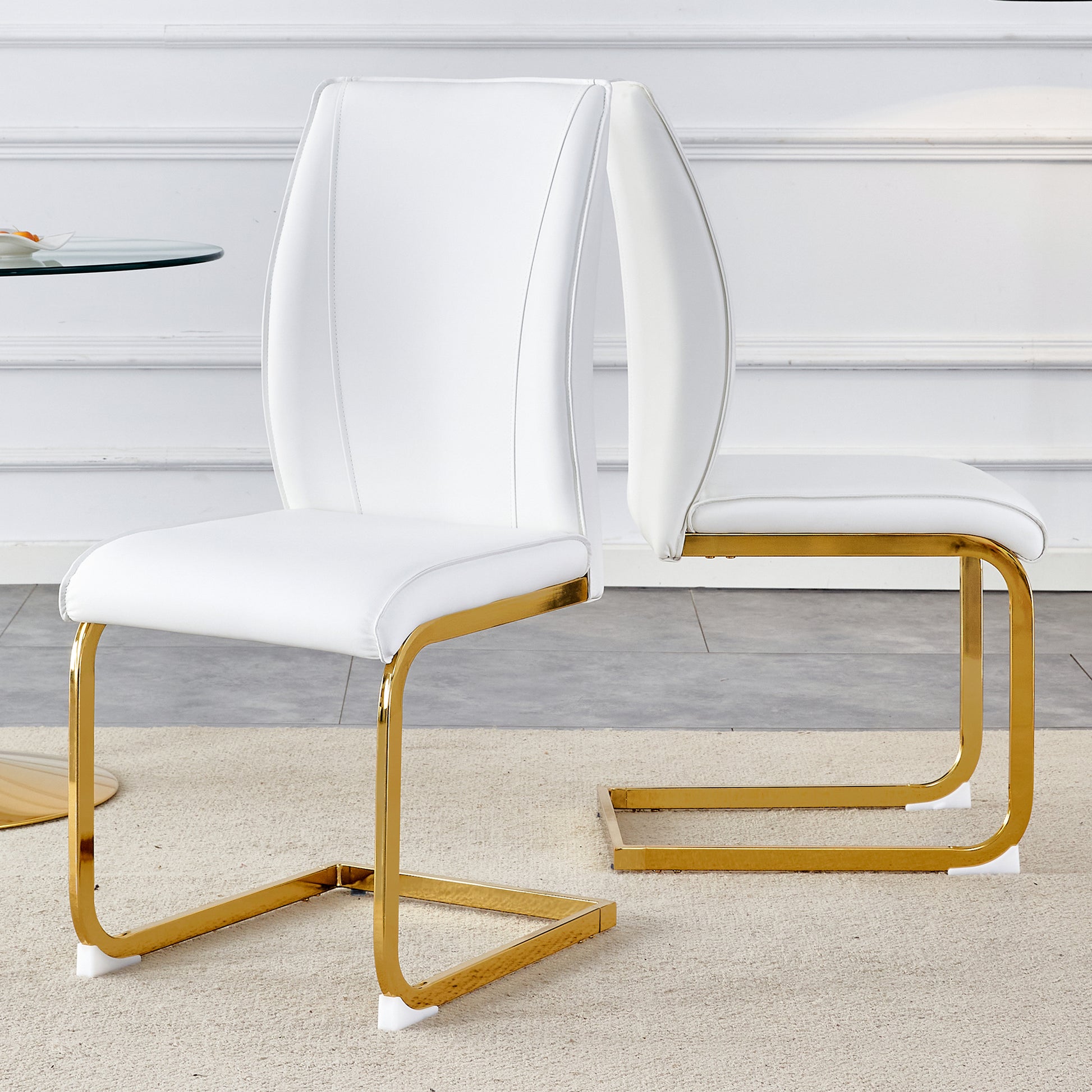 White leather dining chair with polished gold cantilever base and elegant stitching detail