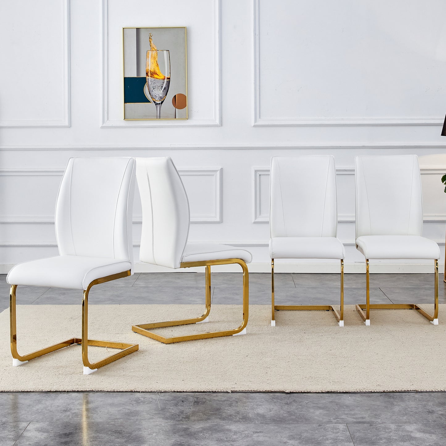 Four white leather dining chairs with gold sled legs on a cream rug