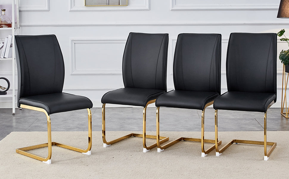 Four black faux leather dining chairs with gold metal sled legs