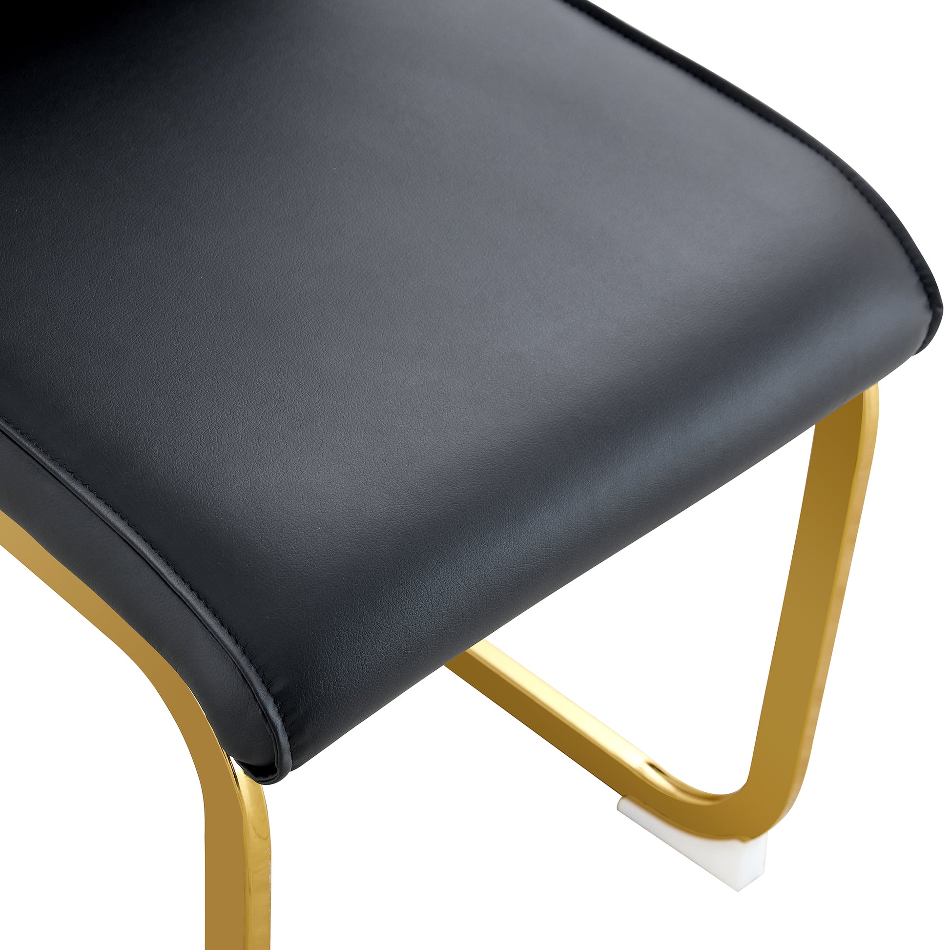 Black faux leather upholstered stool with gold metal legs and white floor protectors