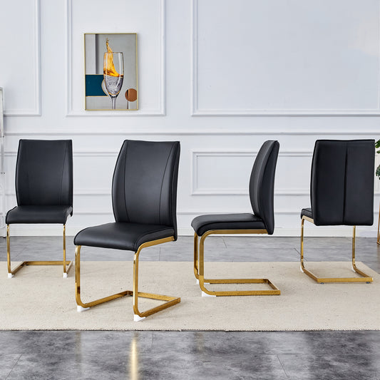 Four black faux leather dining chairs with polished gold sled bases arranged in a room