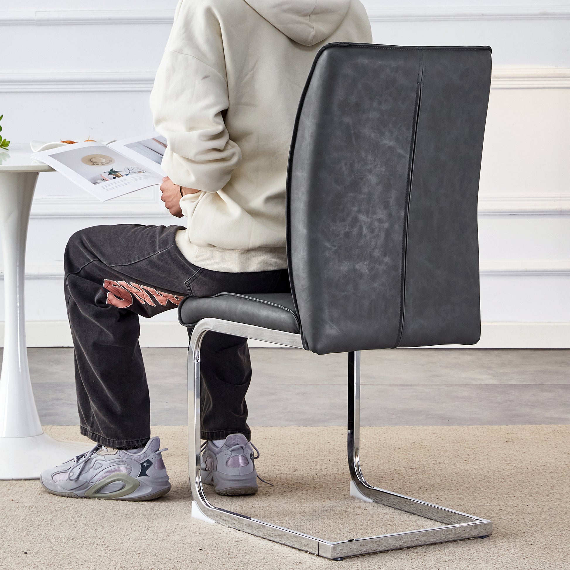 Dark gray faux leather dining chair with a sleek cantilever chrome base