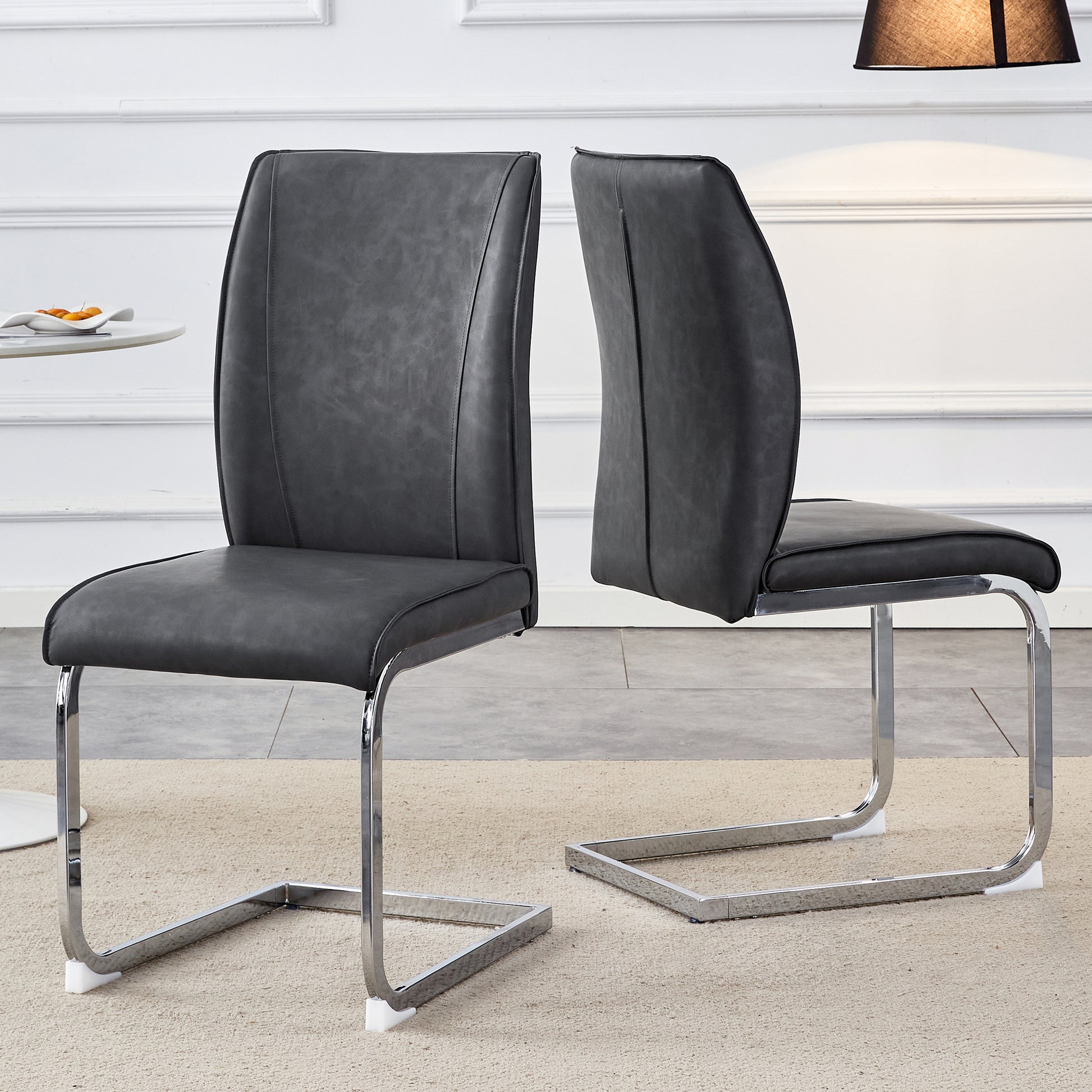 Dark gray faux leather dining chair with chrome cantilever base