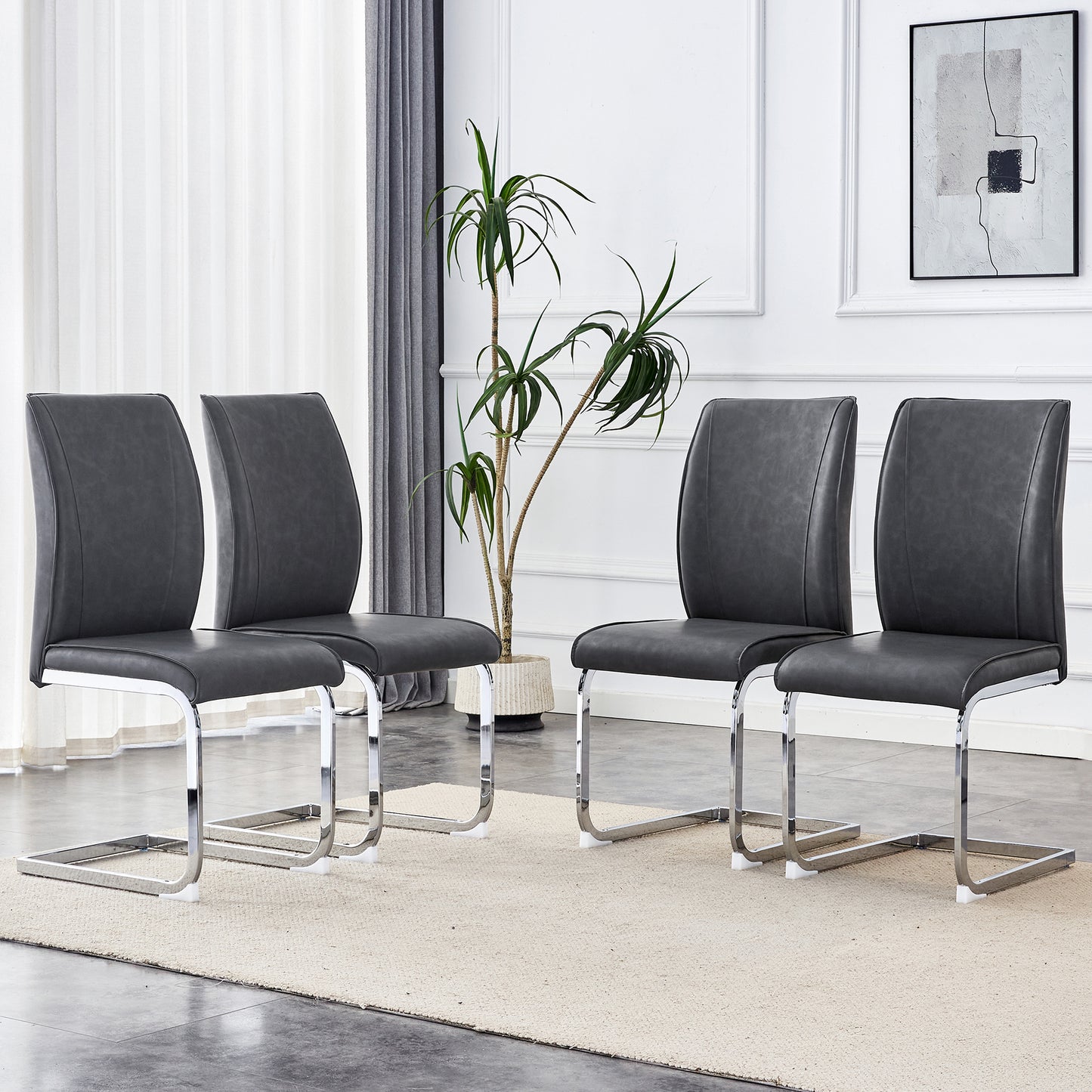Four dark grey faux leather dining chairs with sleek chrome cantilever bases
