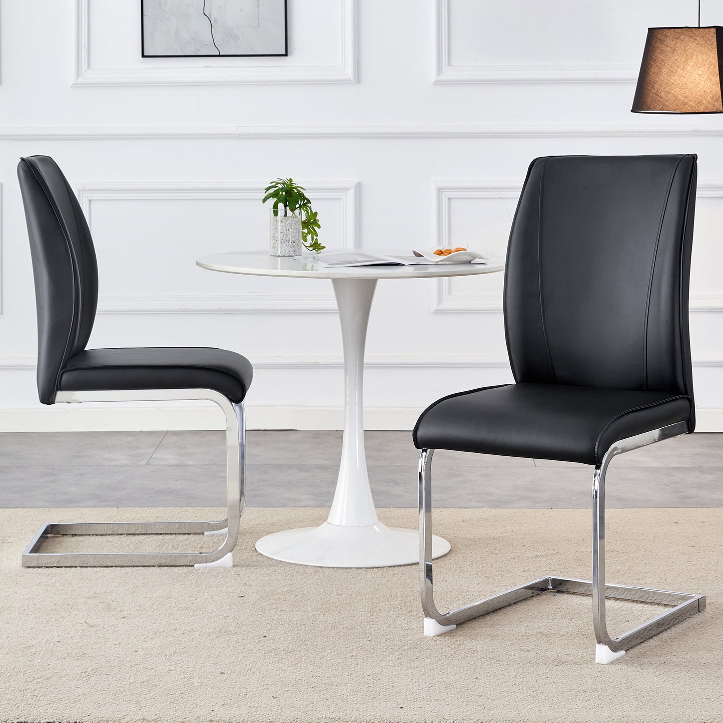 Two black faux leather cantilever dining chairs with chrome legs modern design