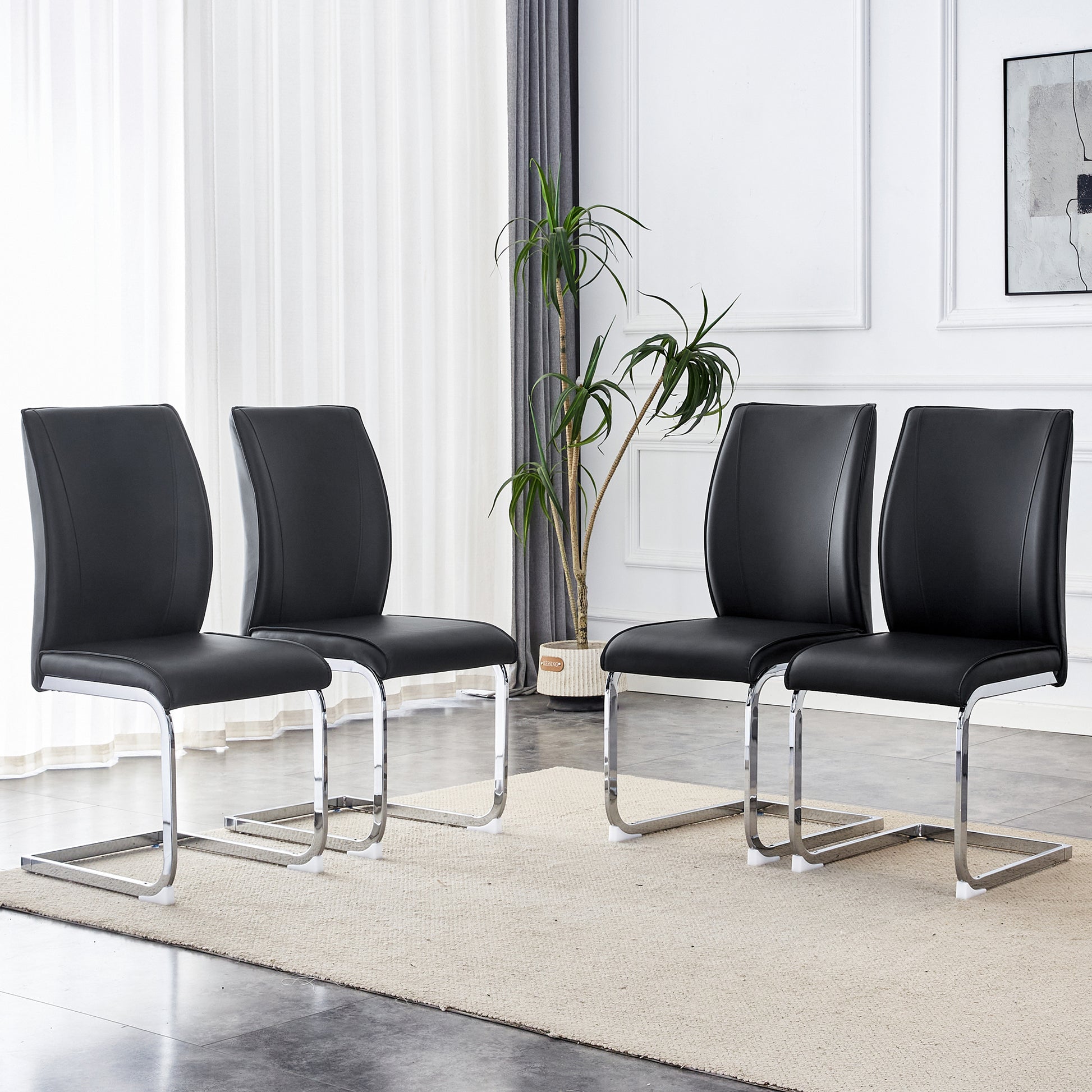 Four black faux leather dining chairs with chrome cantilever bases arranged around a rug
