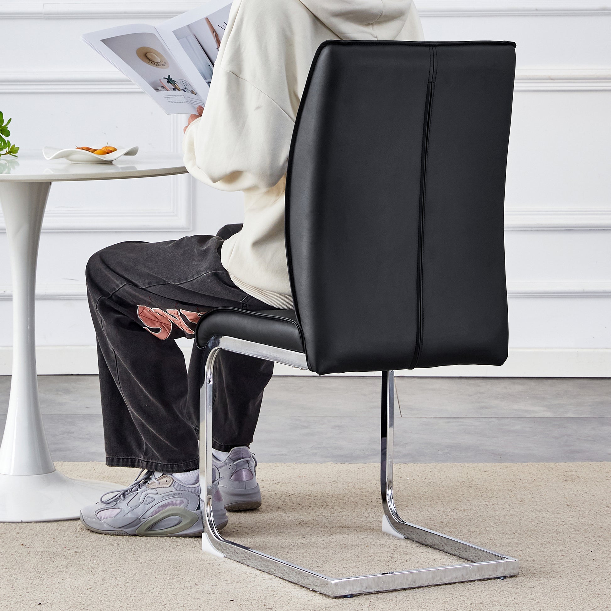 Sleek black faux leather dining chair with chrome cantilever base perfect for modern homes