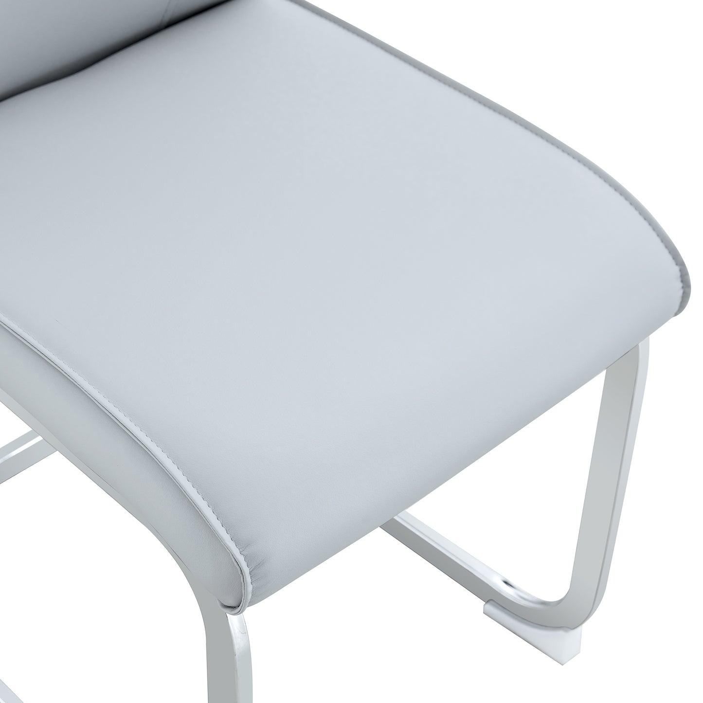 Closeup of light gray faux leather upholstered chair seat with white frame