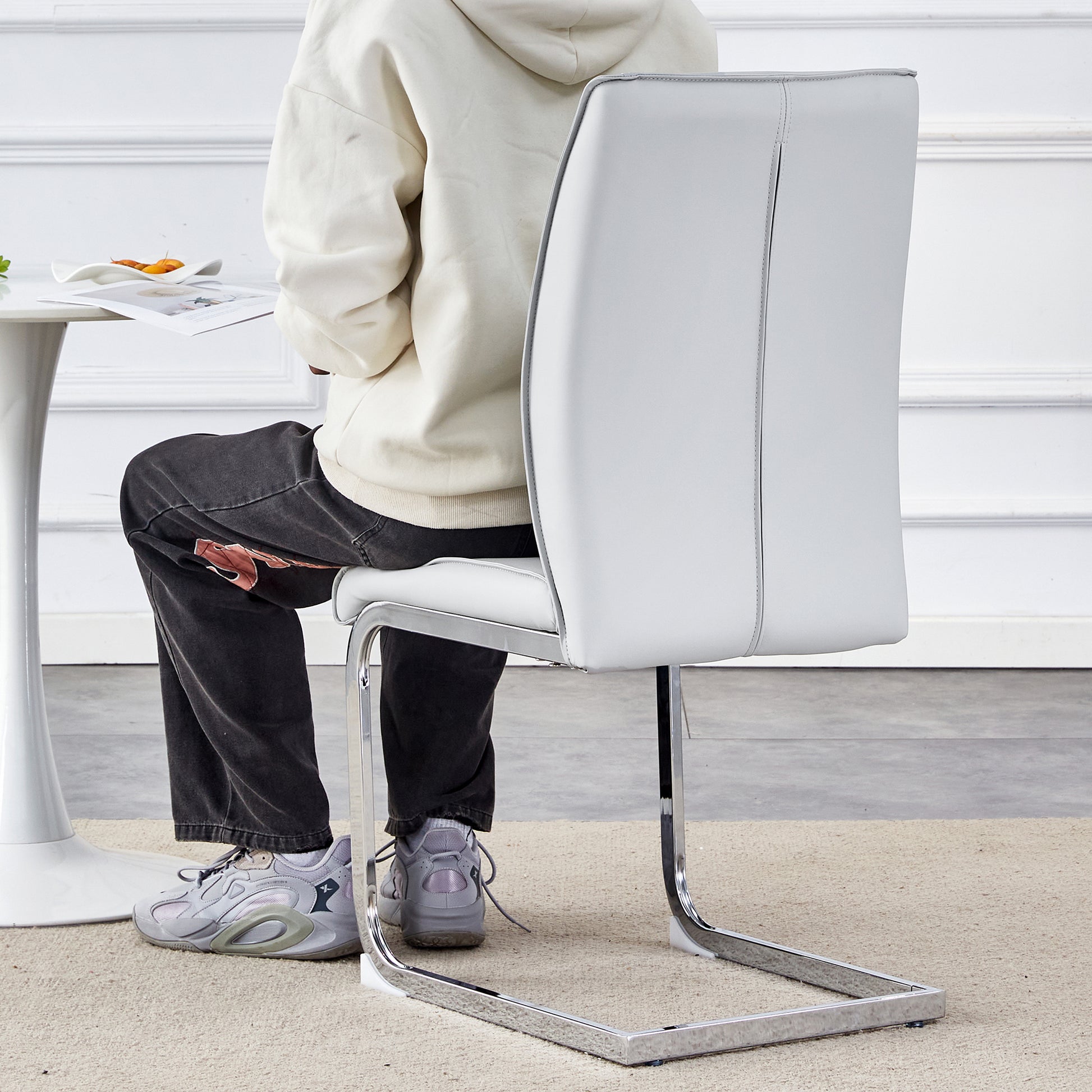 White faux leather dining chair with chrome sled base