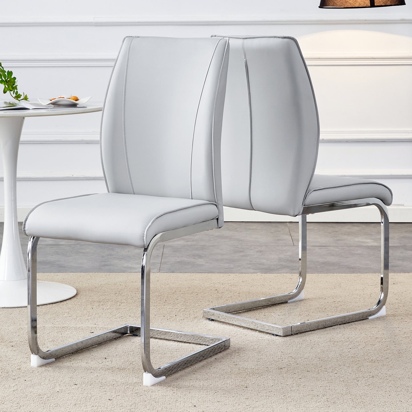 Light grey faux leather dining chair with silver chrome sled legs