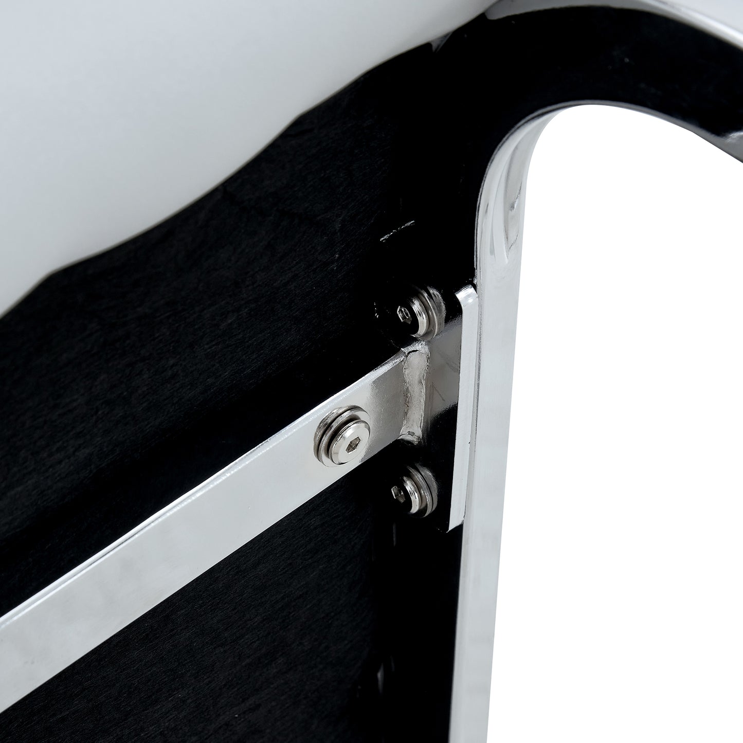 Polished chrome metal bracket with hex bolts attached to black textured panel
