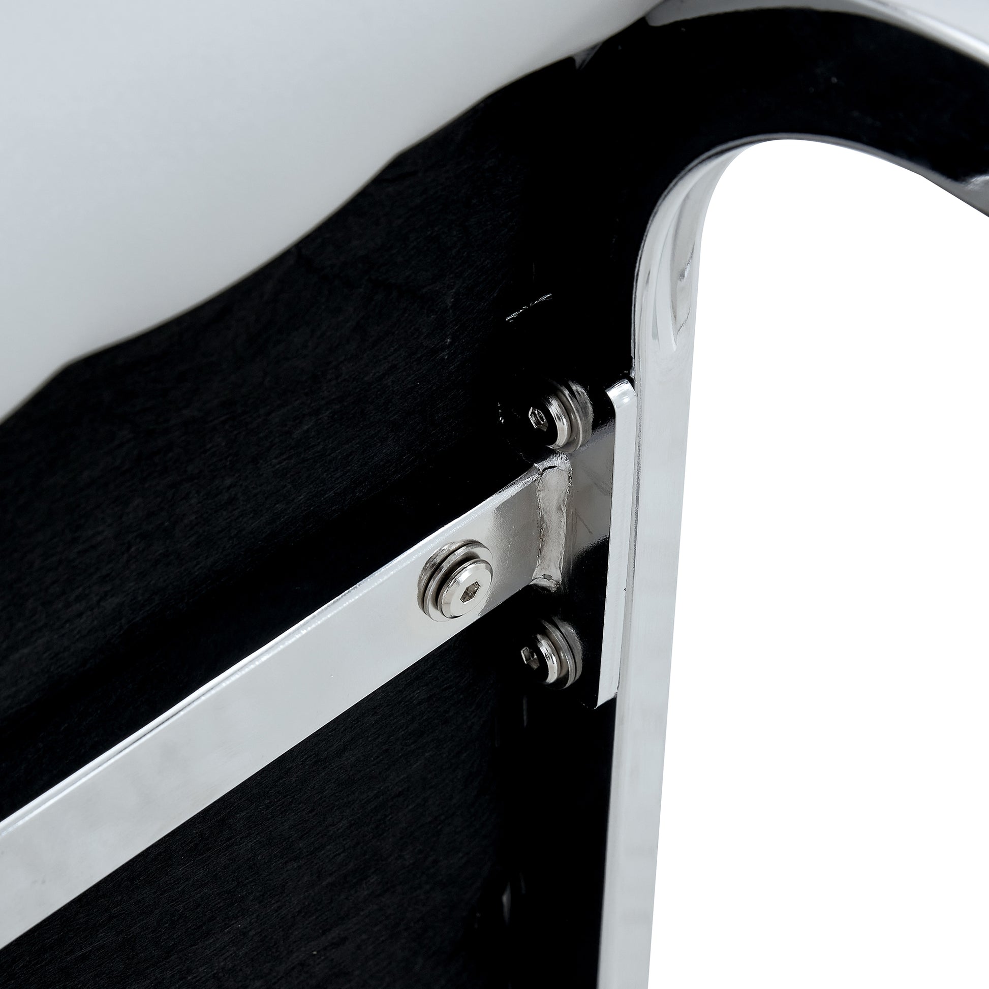 Polished chrome metal bracket with hex bolts attached to black textured panel
