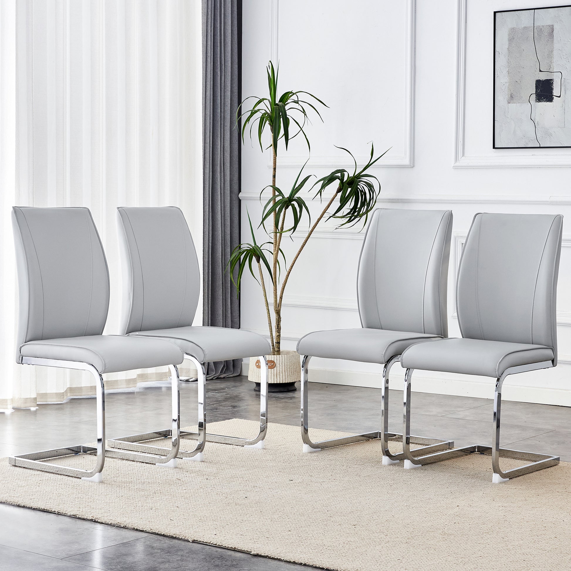 Set of four grey faux leather dining chairs with chrome sled base