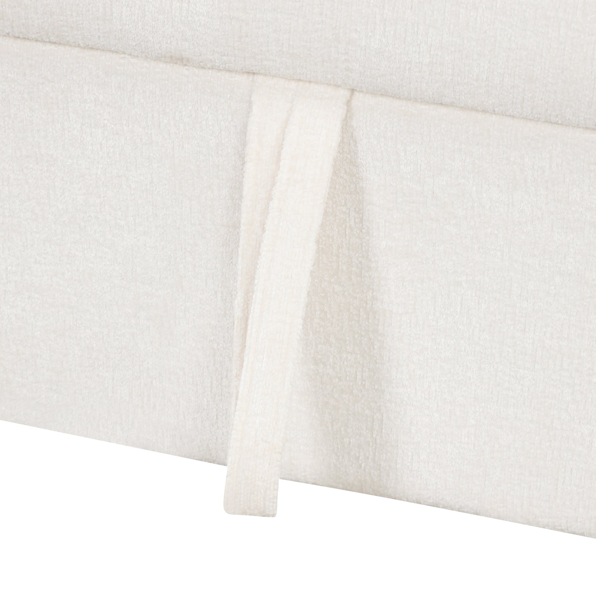 Offwhite boucle textured fabric on a sofa skirt with a handle detail
