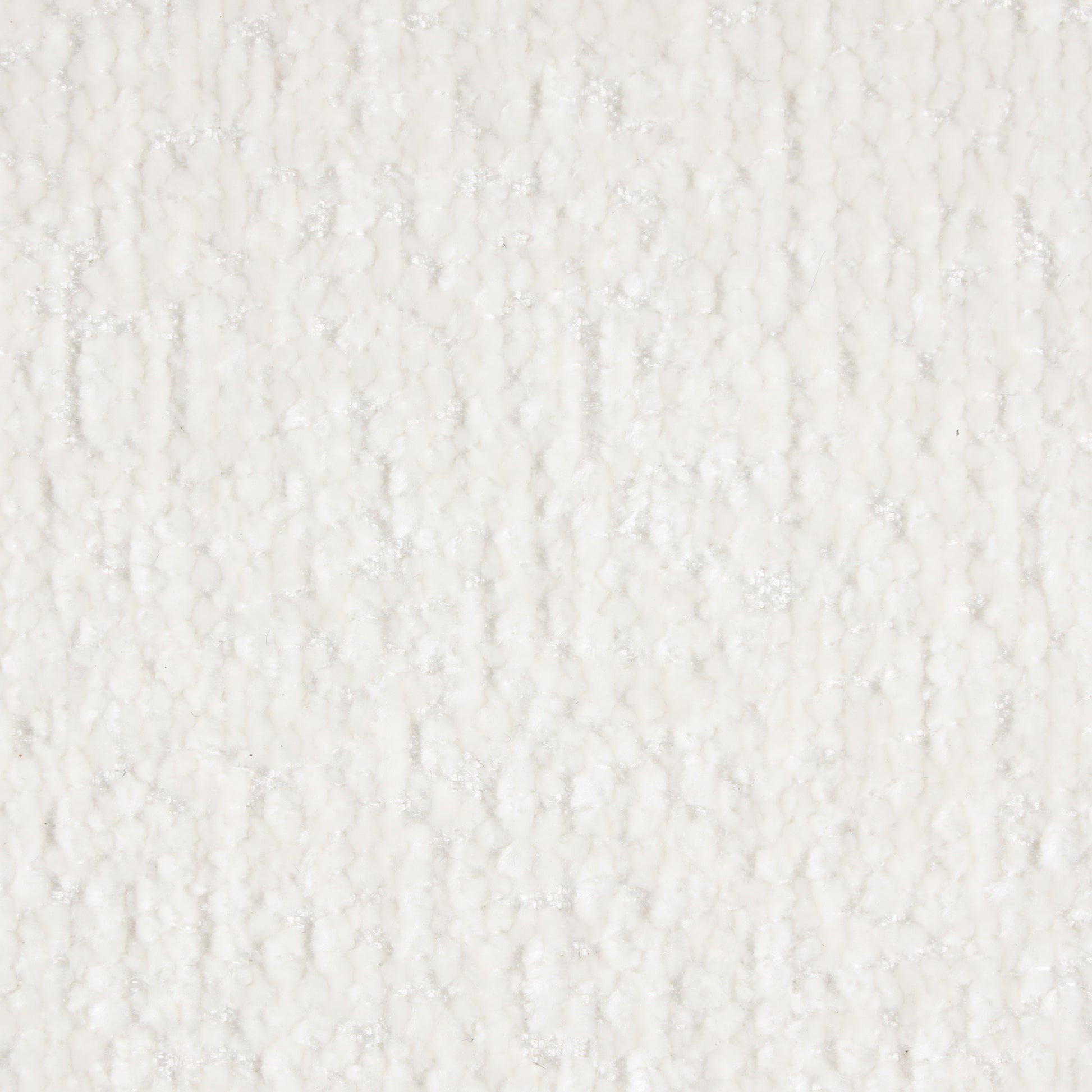 Closeup of a textured white fabric with raised irregular bumps and a slight shimmer