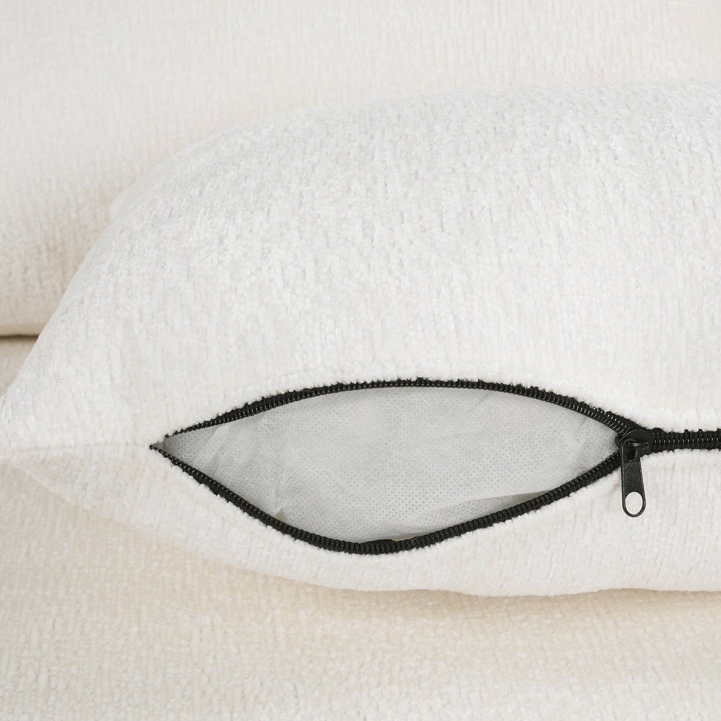 White boucle throw pillow detail with black zipper closure revealing inner filling